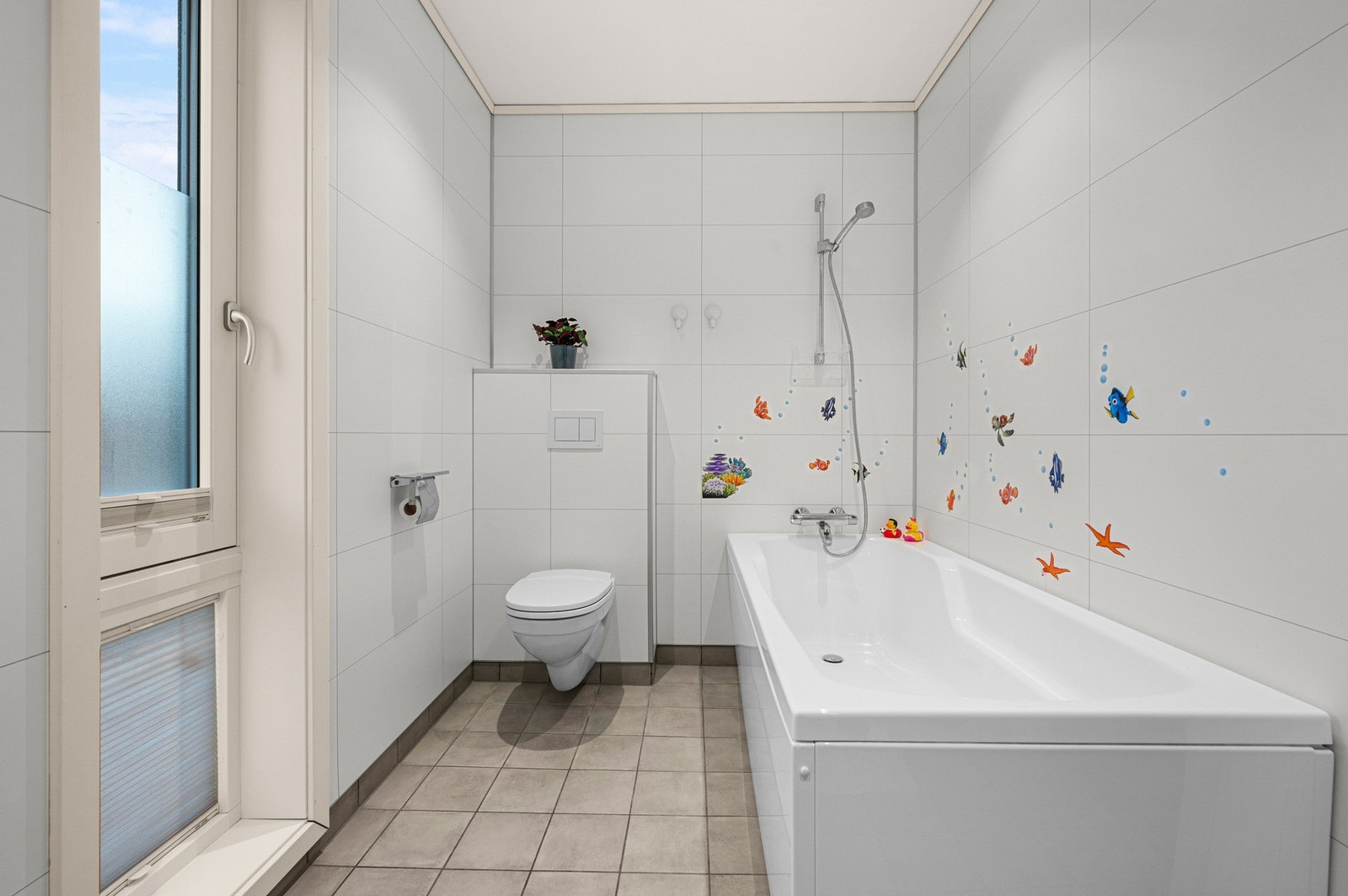 Flislagt bad med badekar i samme etasje som soverommene - perfekt for barnefamilier Galleribilde