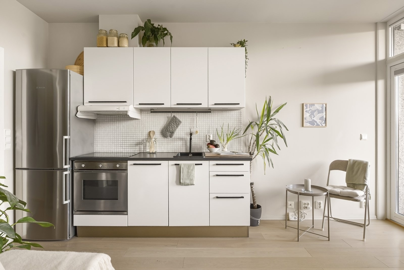 Lyst og pent kjøkken fra 07/08 med glatte fronter og laminat benkeplate. Galleribilde