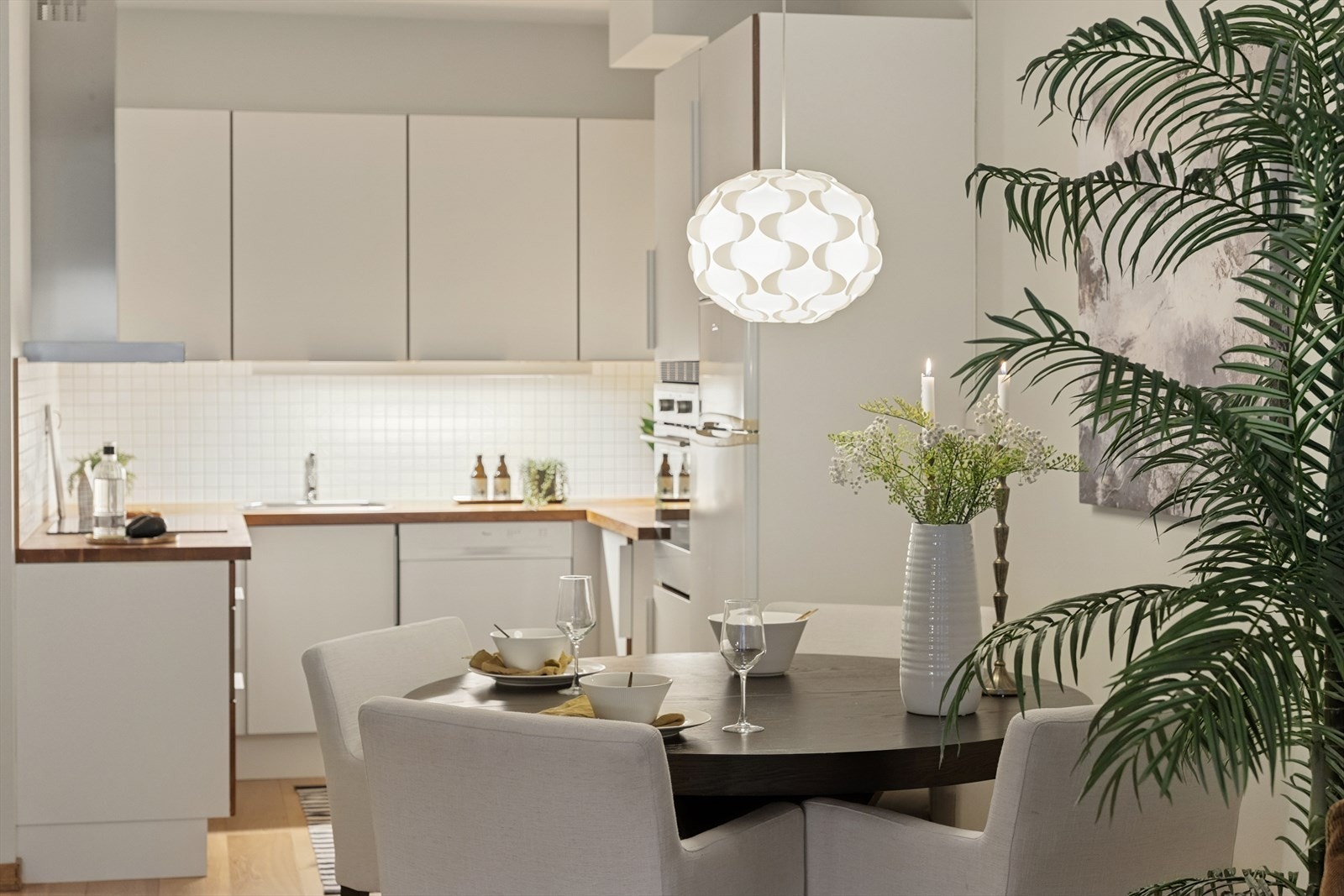 Kjøkkenet er inntrukket og inneholder det man trenger av oppbevaring og benkeplass Galleribilde