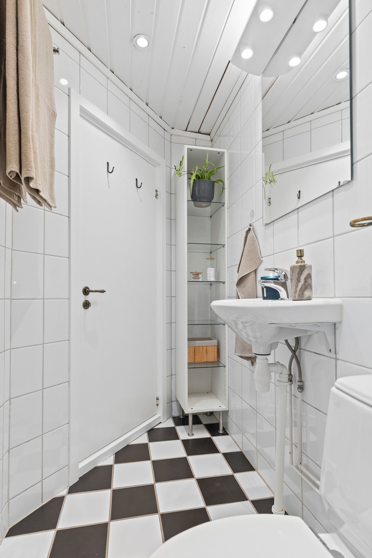 Innredning med vegghengt servant og gulvstående toalett. Galleribilde