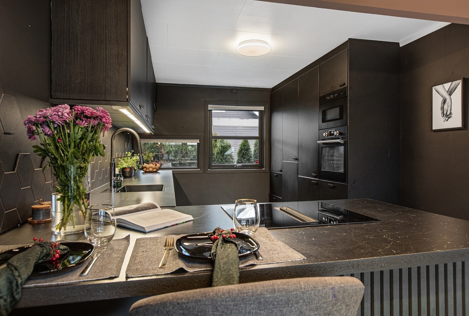 Kjøkkenøya har integrert platetopp og fungerer som en ekstra arbeidsflate og spiseplass. Galleribilde