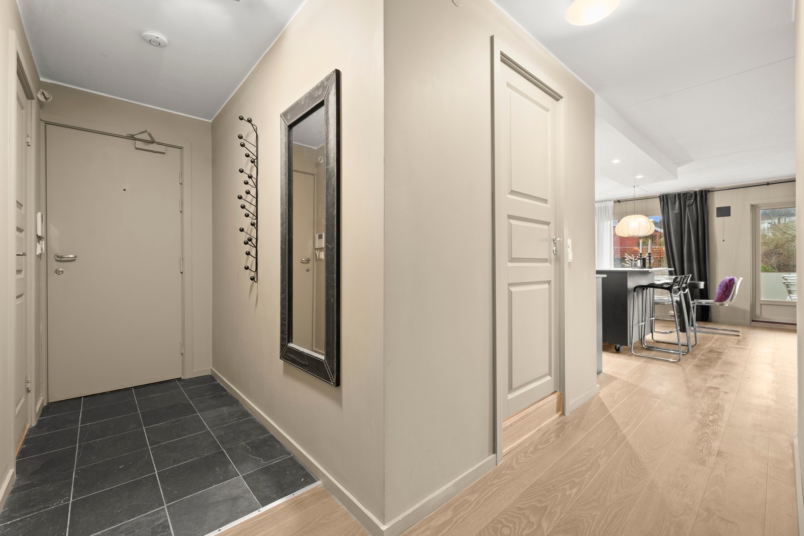 Lys og innbydende entré med god plass til yttertøy og sko i avskildt garderobe/bod. Galleribilde