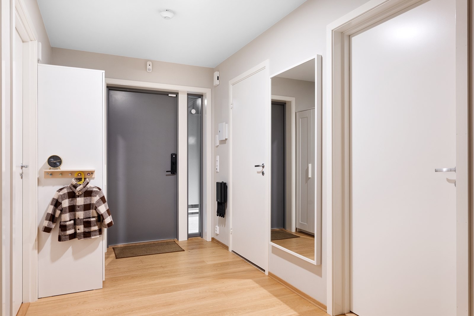 Entre med plass til å henge av seg yttertøy. Det er varmekabler i halve gangen Galleribilde