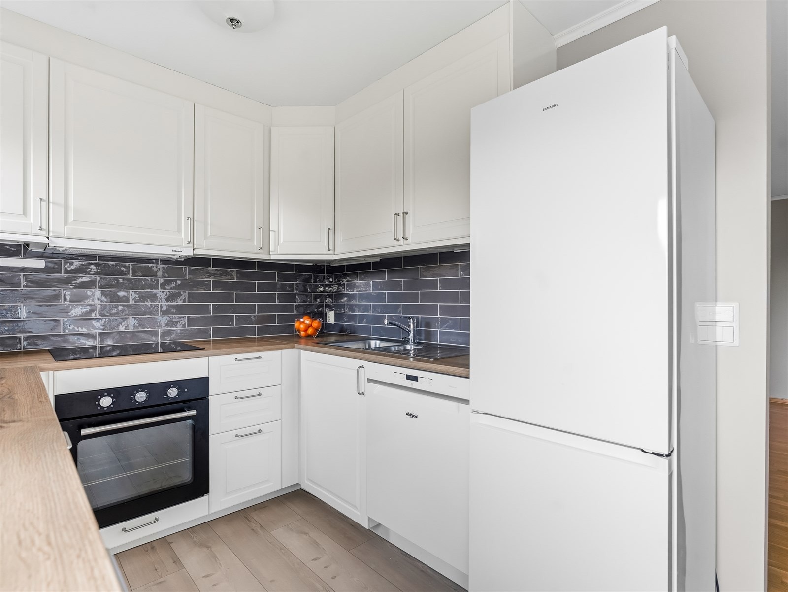 Innredningen har skap med profilerte fronter, samt en laminat benkeplate med nedfelt kum i rustfritt stål. Galleribilde