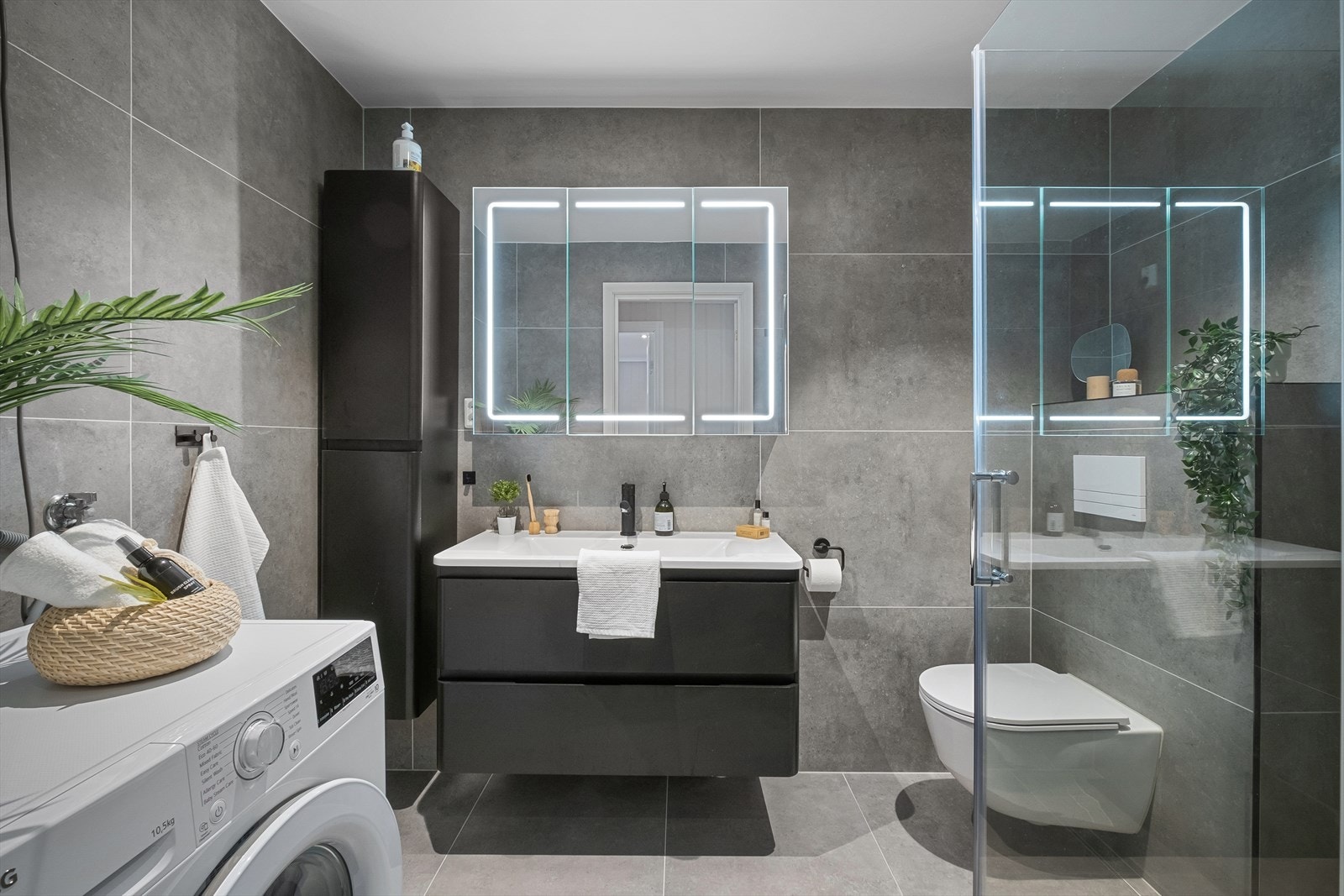 Nytt flislagt bad i 2022 med dusjhjørne, veggfestet wc, vask m/skap og opplegg for vaskemaskin Galleribilde