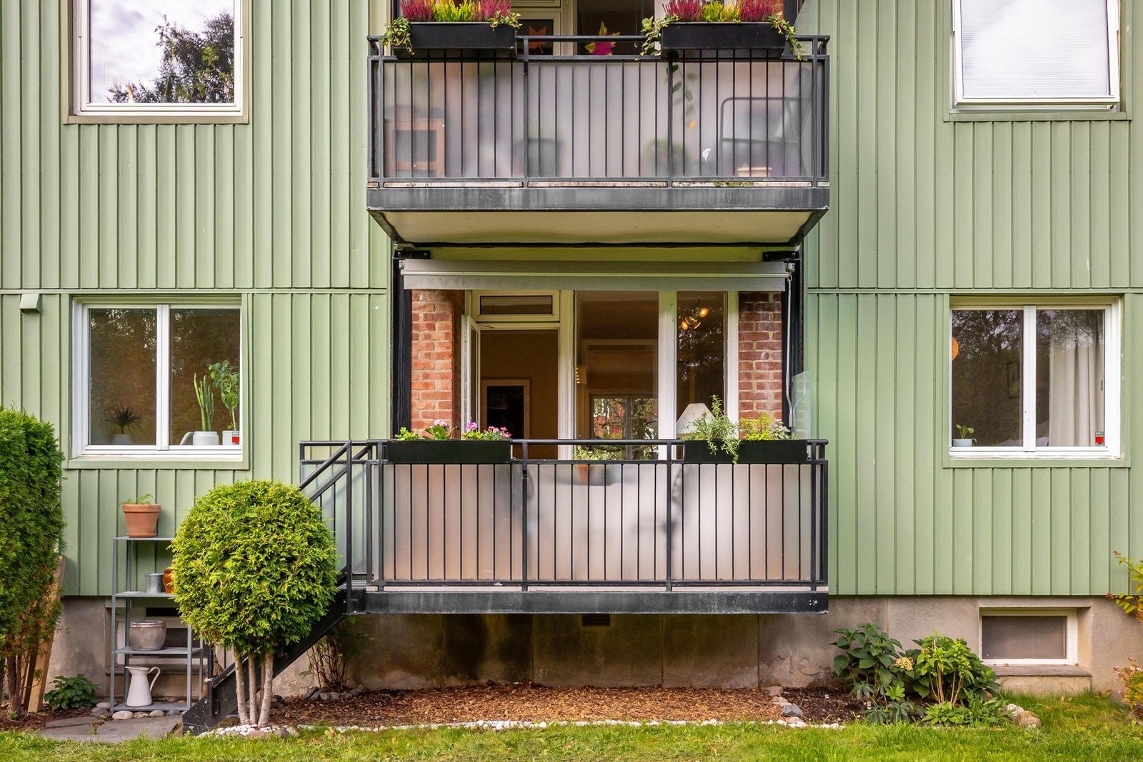 Byggets fasade er velholdt, og her ser man den praktiske trappen fra balkongen. Galleribilde