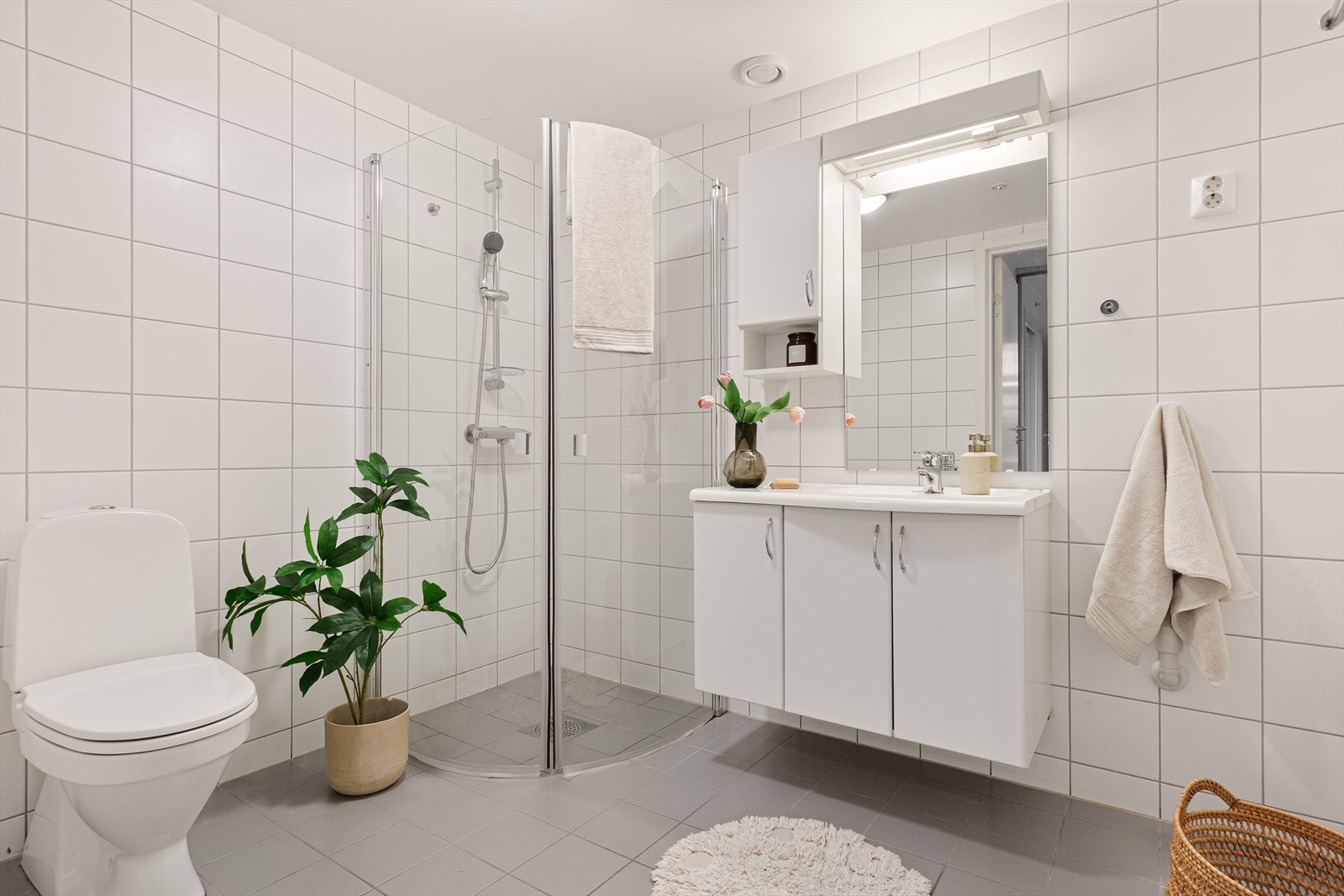 Stort og romslig bad med flislagte overflater. Pent innredet med tidløs baderomsinnredning og gode oppbevaringsløsninger. Galleribilde