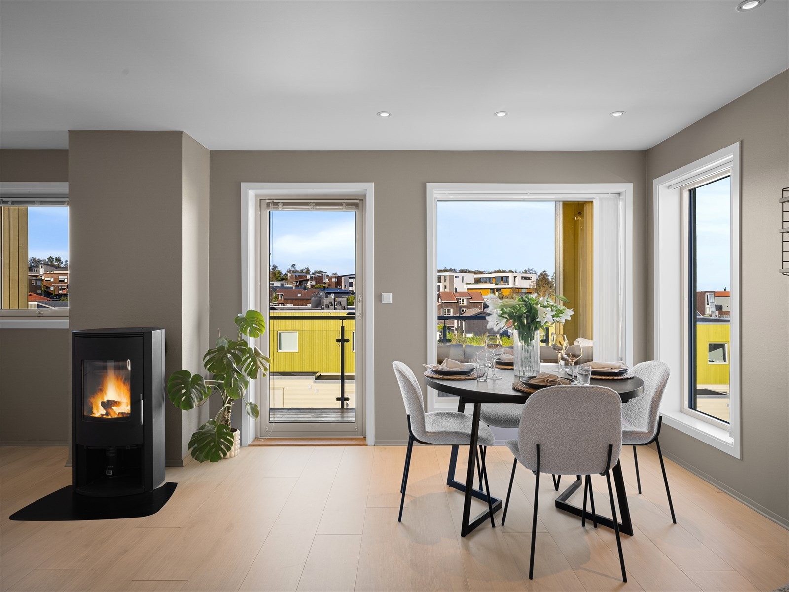 Romslig stue med store vindusflater som lar lyset flomme inn og skaper en harmonisk atmosfære, samt flott og integrert peisovn Galleribilde