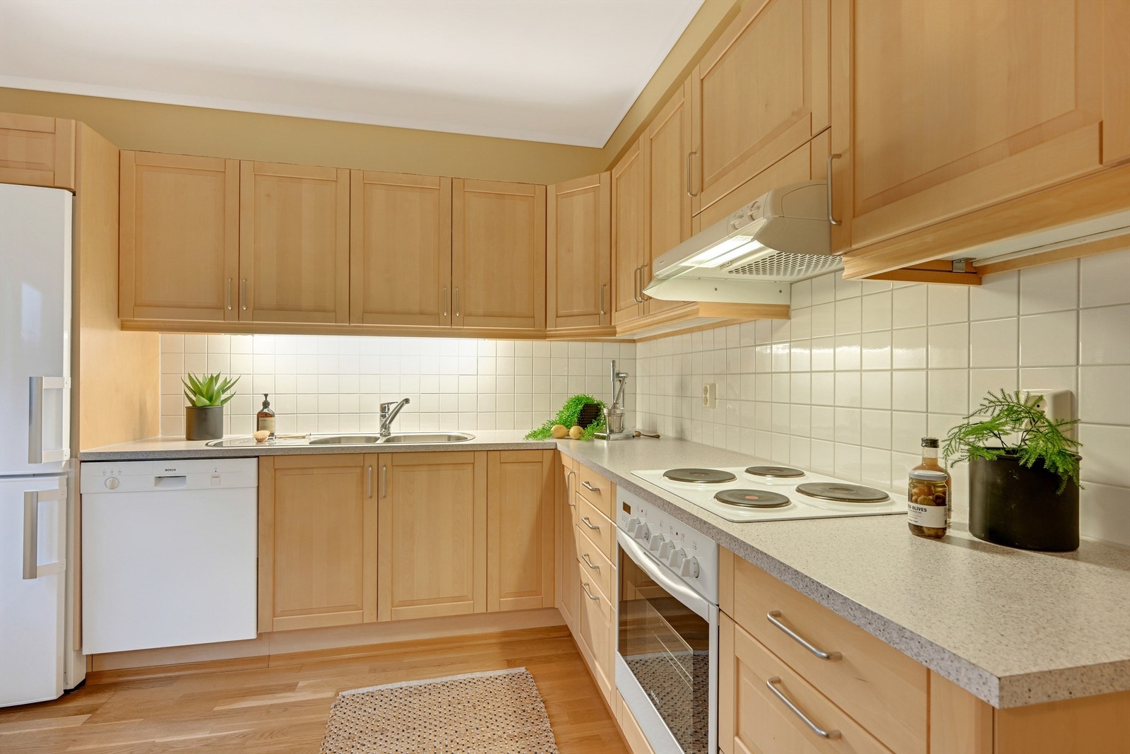 Kjøkkenet har innredning med profilerte fronter og laminert benkeplate Galleribilde