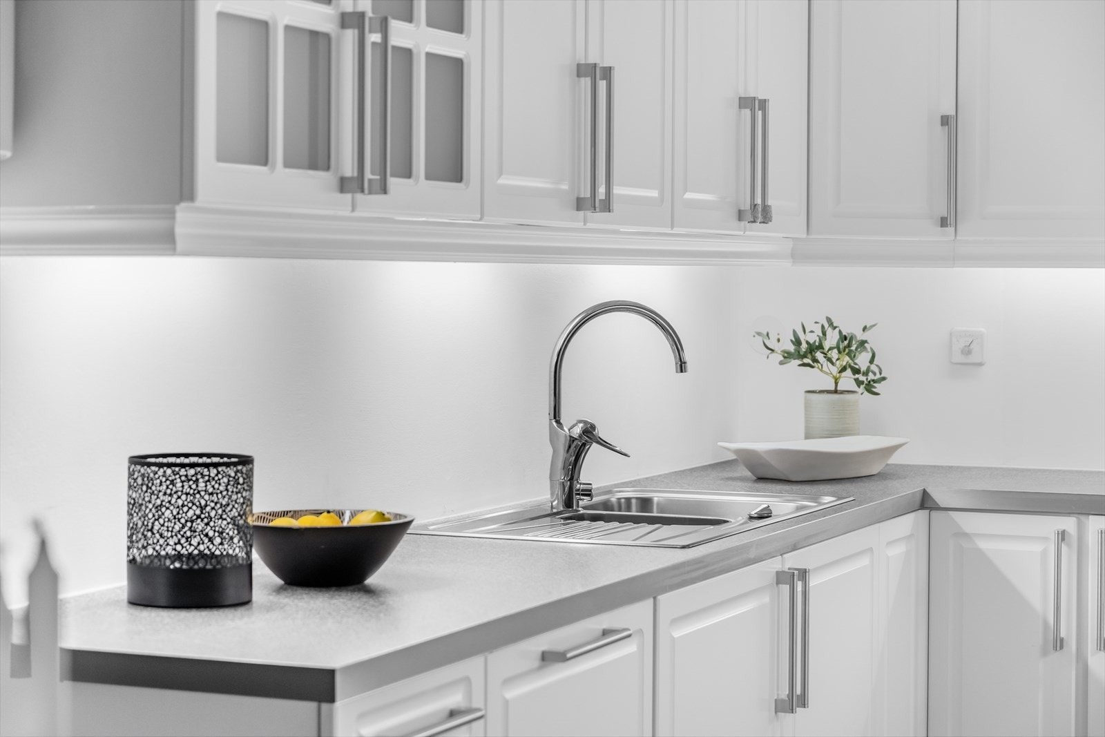 Benkeplaten er av laminat med en nedfelt kum i rustfritt stål og ett-greps blandebatteri. Galleribilde