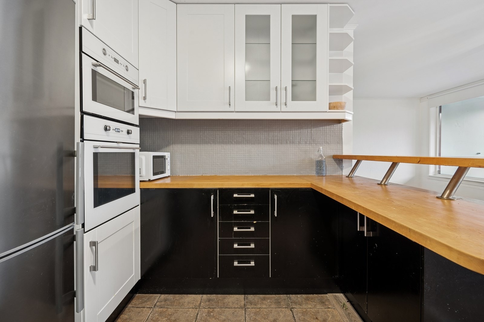 Kjøkkenet innehar integrerte hvitevarer som platetopp, stekeovn, mikrobølgeovn og oppvaskmaskin Galleribilde