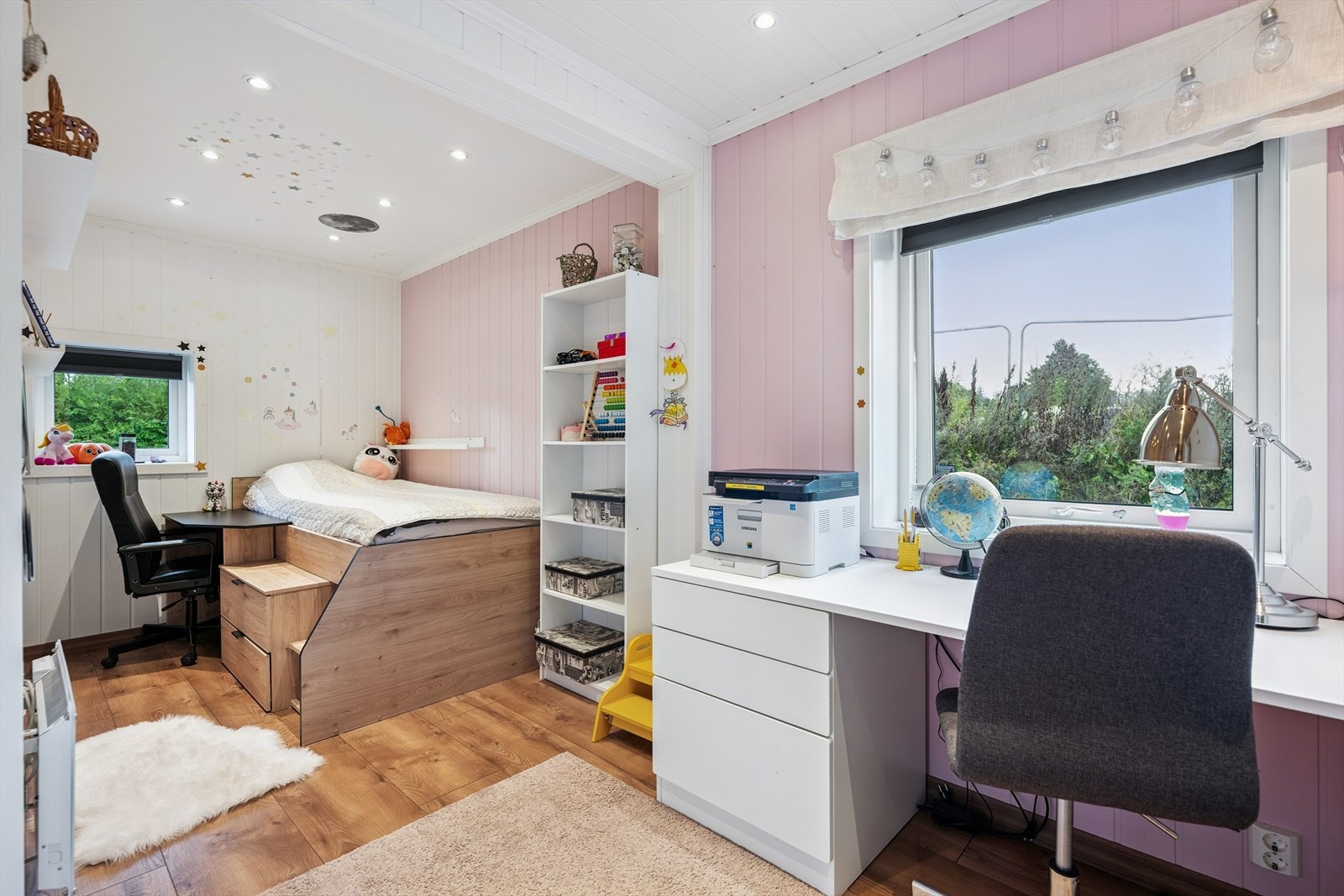 Lyst og romslig soverom med laminat på gulv, panel på veggene og panel med spotter i tak. Galleribilde