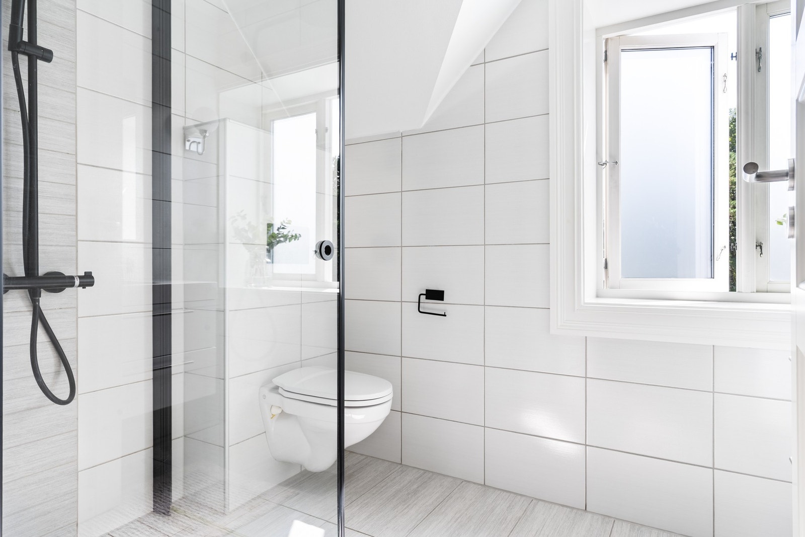 Funksjonelt baderom med toalett, dusjhjørne og opplegg for vaskemaskin/tørketrommel, også med varmekabler i gulv. Galleribilde