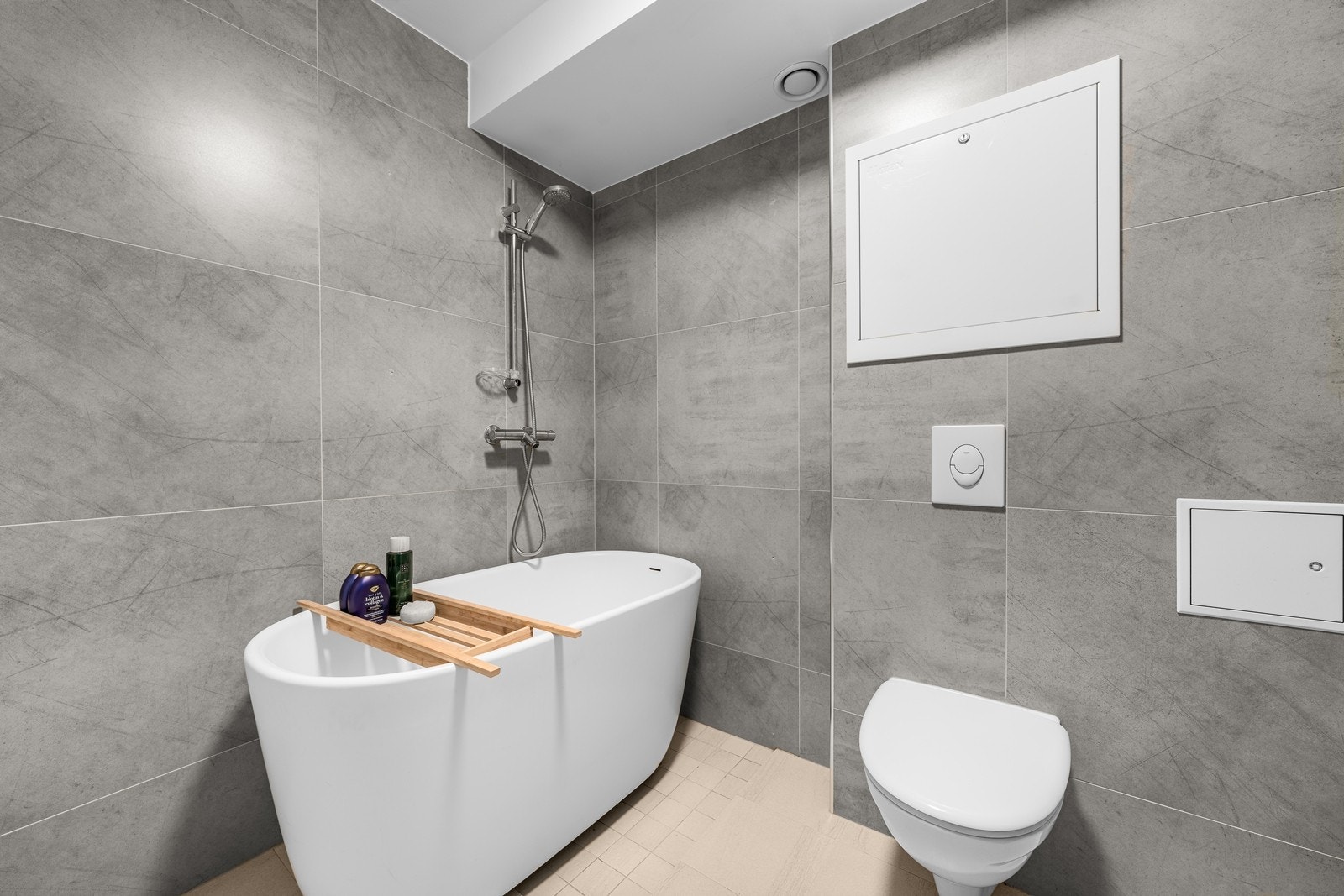 ommet er videre utstyrt med badekar med dusjbatteri, samt vegghengt klosett med innebygget sisterne. Det er også opplegg for vaskemaskin, noe som gjør badet både funksjonelt og godt tilpasset en moderne hverdag. Galleribilde