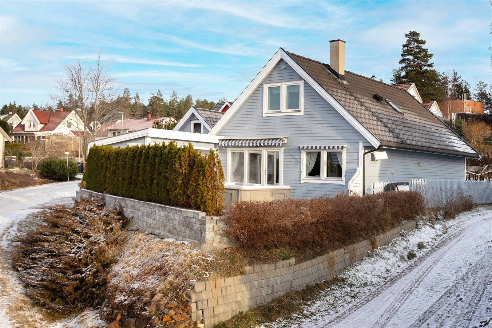 Eiendommen har en stor, steinbelagt gårdsplass med rikelig biloppstillingsplass og en frittstående dobbelgarasje. Galleribilde