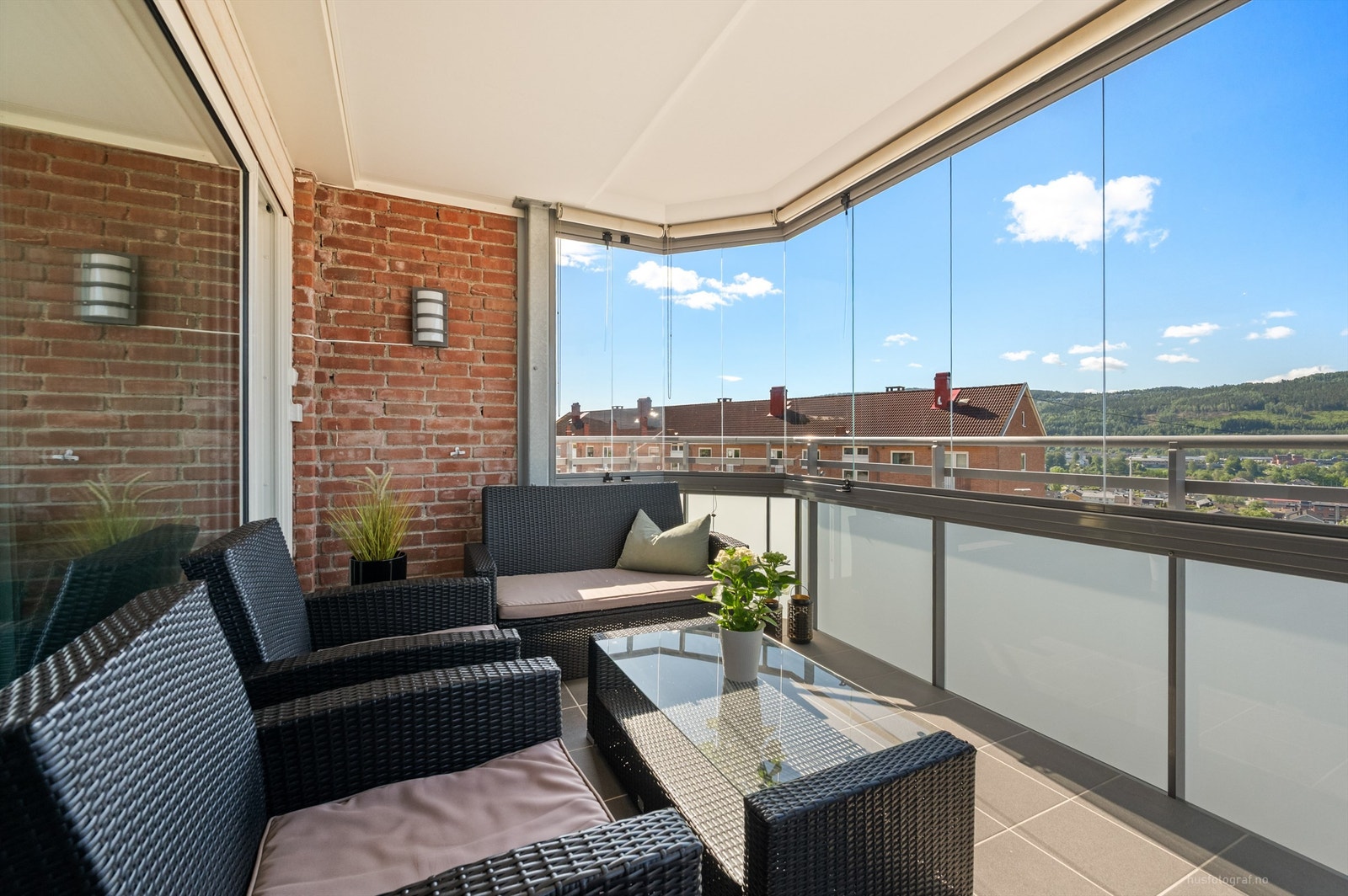 Balkongen har flislagt dekke, utvendig belysning, skyvbare glassfelt og innvendig solskjerming Galleribilde