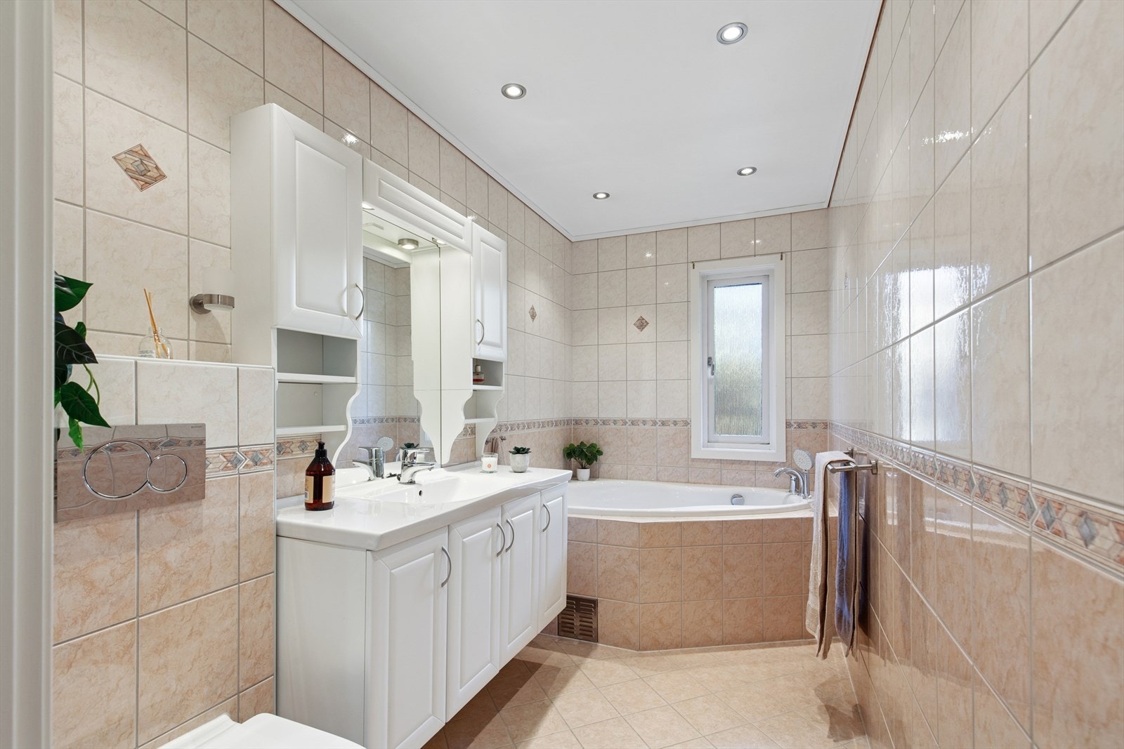 Badet i første etasje fra 2003 og har fliser på vegger og gulv, samt malte flater i taket. Det er installert gulvvarme og downlights. Sanitærutstyr og innredning fra 2003, ny sisterne i 2023. Galleribilde