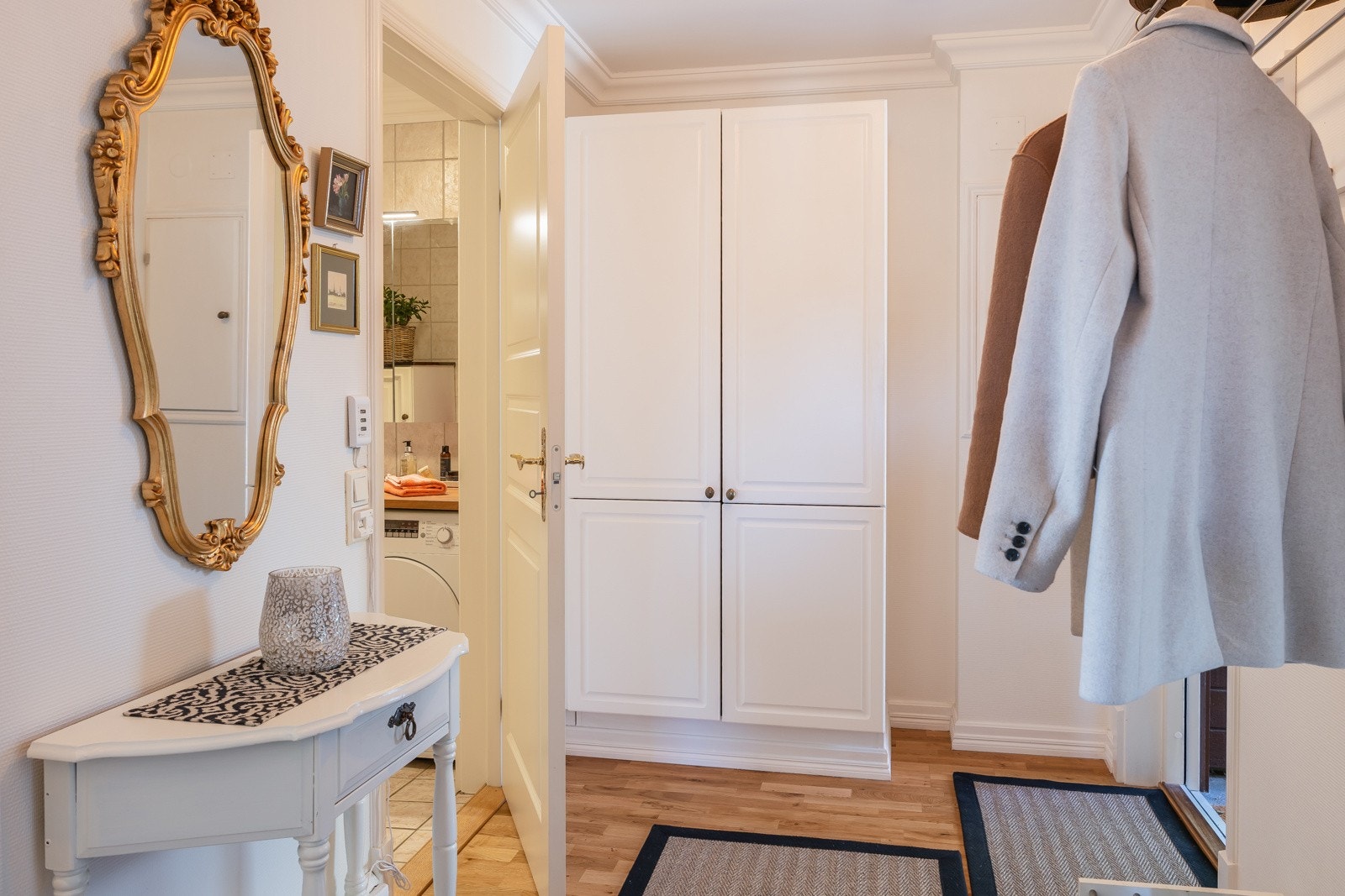 Lys og tiltalende entré med god plass for oppbevaring av yttertøy og sko i et praktisk garderobeskap Galleribilde