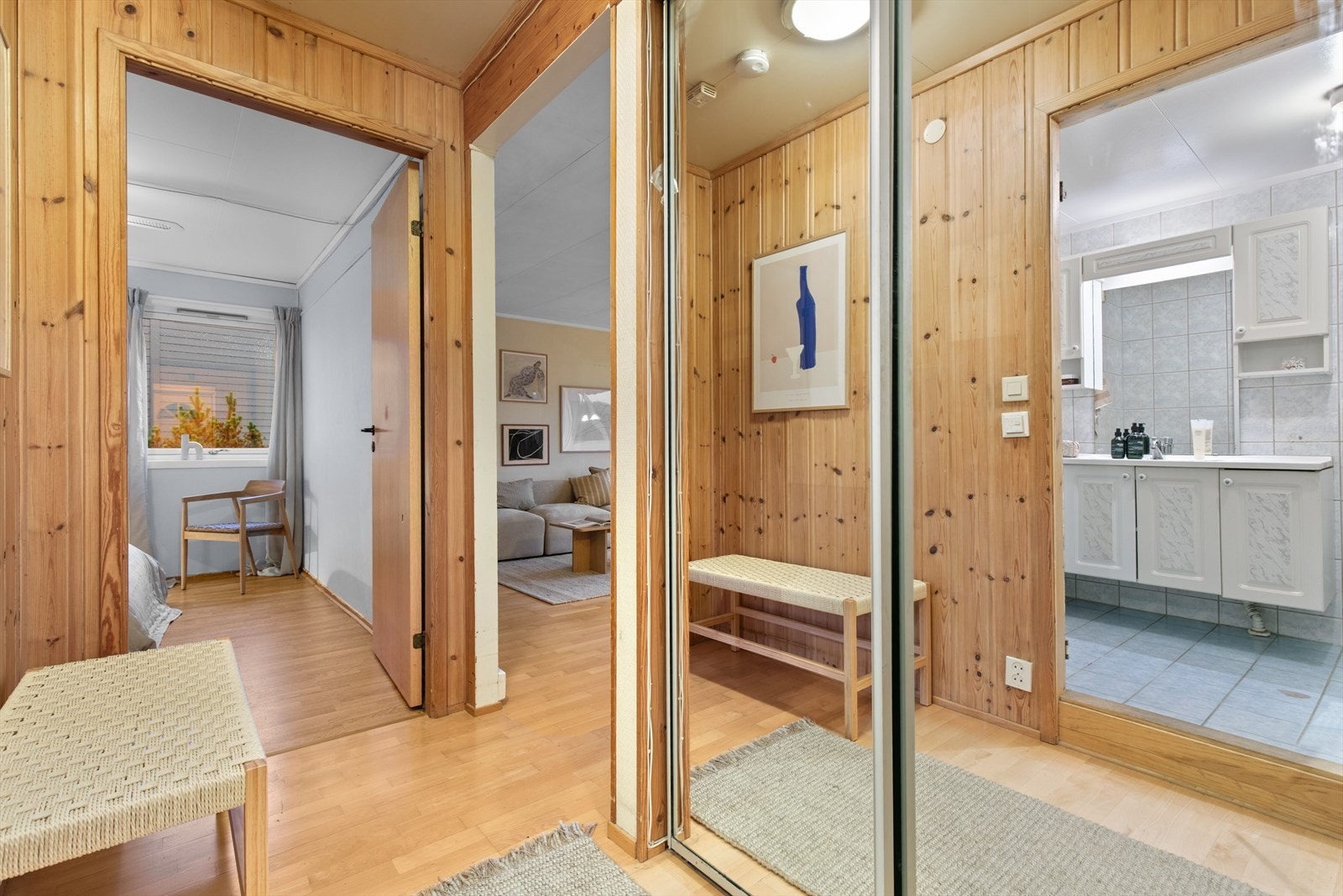 Entréen har panelte vegger og parkettgulv, med tilgang til både stue og bad. Galleribilde