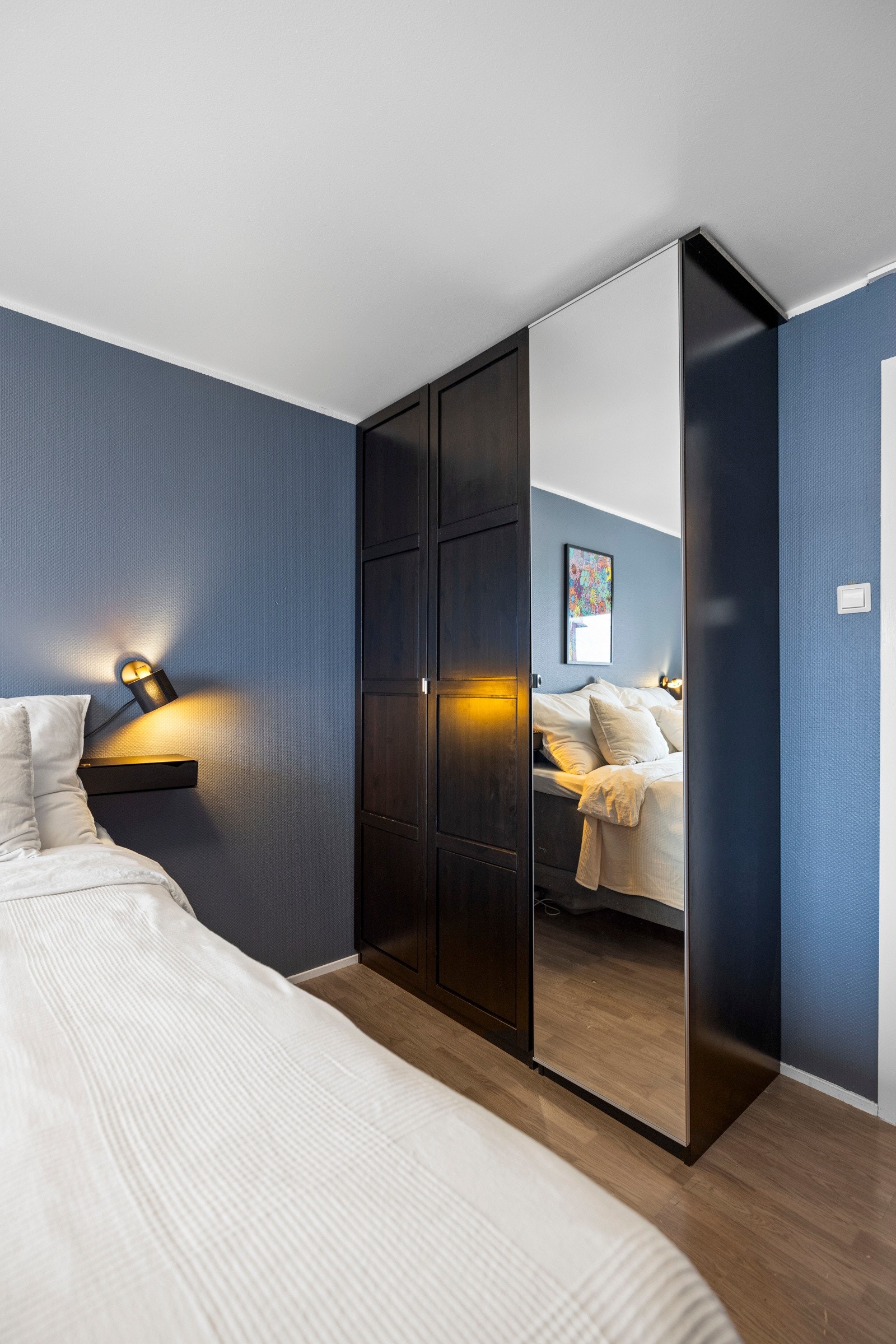 Klærne ryddes enkelt bort i et stort garderobeskap Galleribilde