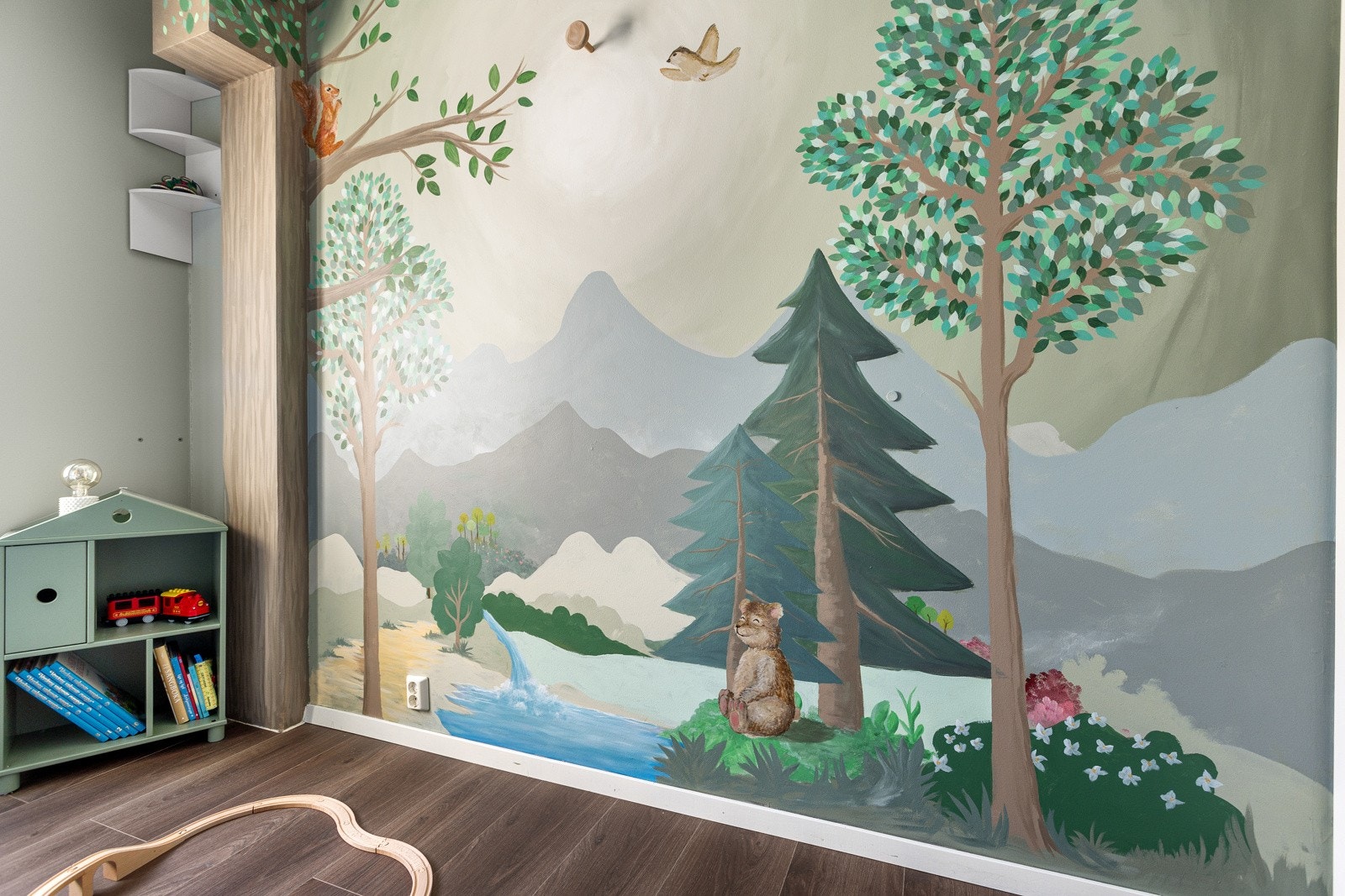 Den ene veggen har et vakkert håndmalt maleri med skogsmotiv til glede for de minste Galleribilde