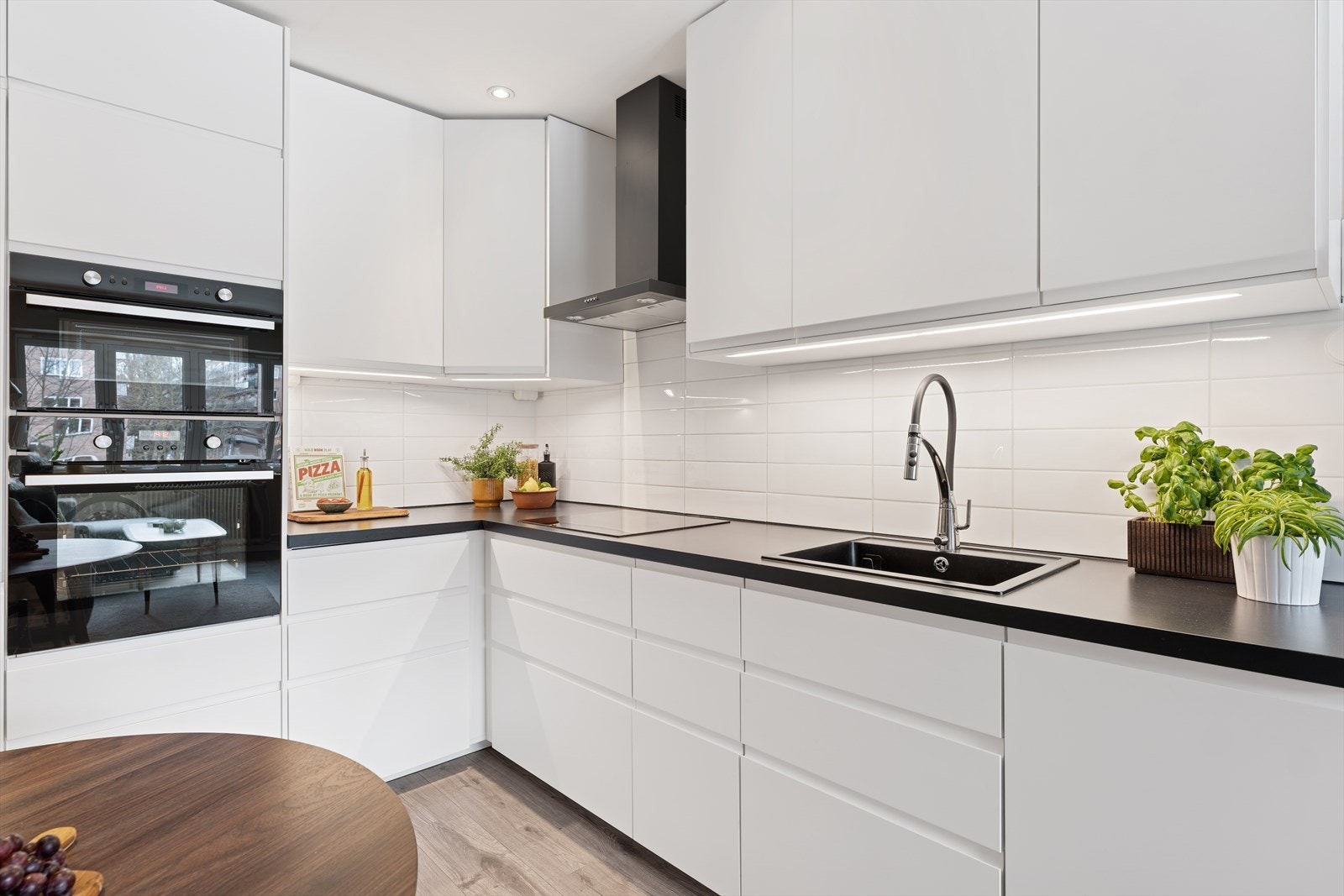 Hvitevarene inkluderer induksjonstopp, stekeovn, oppvaskmaskin, mikrobølgeovn, samt kjøl- og fryseskap. Galleribilde