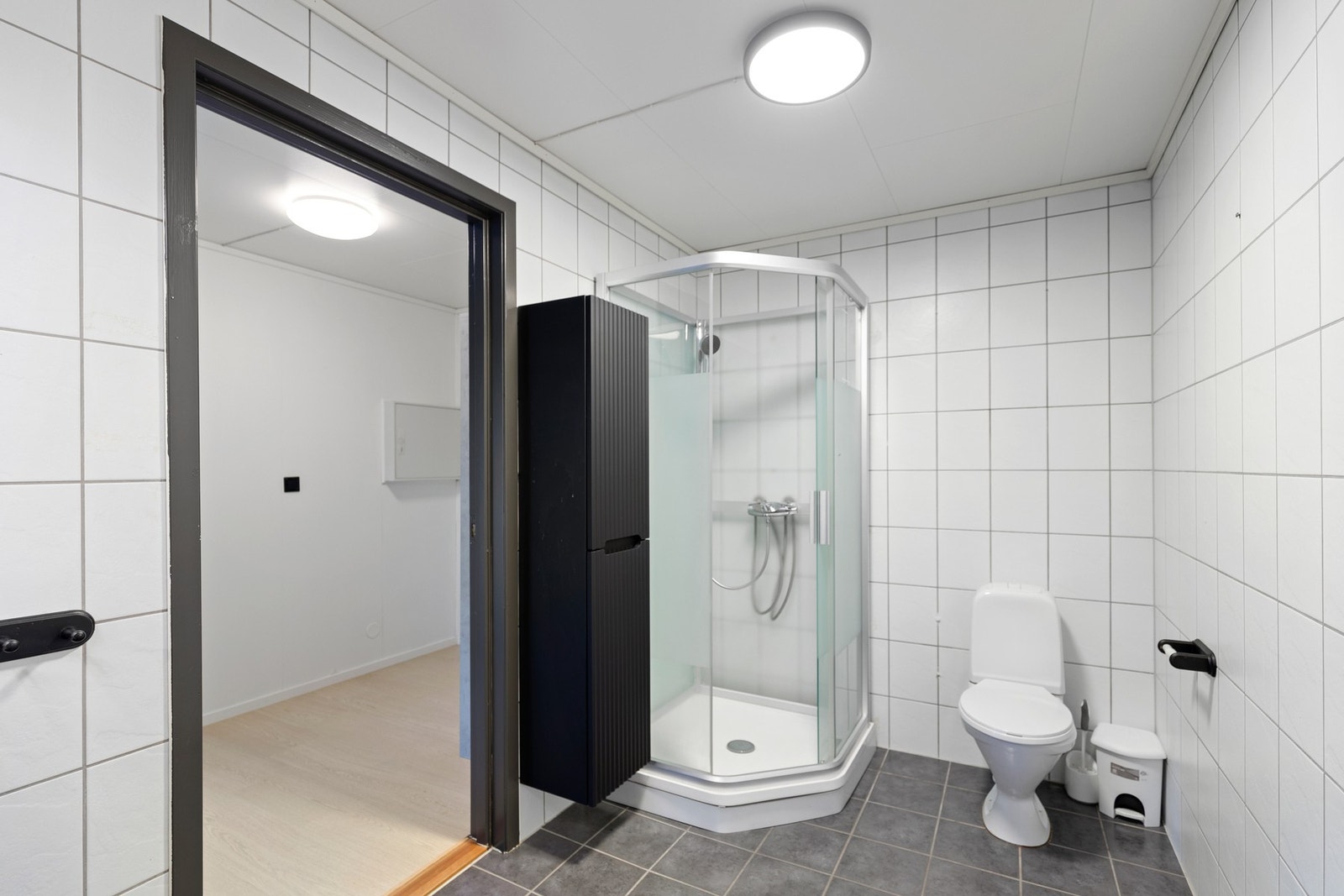 Badet har flislagt gulv med gulvvarme, og fliskledde vegger Galleribilde
