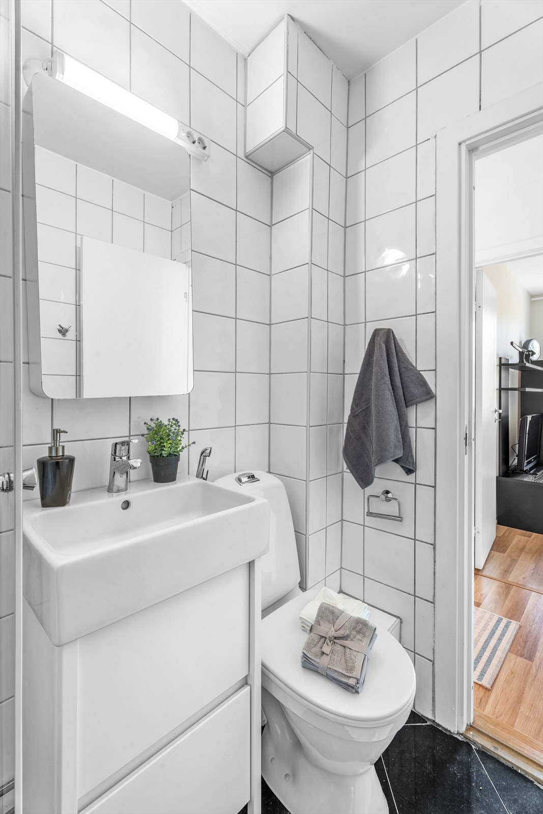 Badet er pent flislagt i tidløse farger Galleribilde