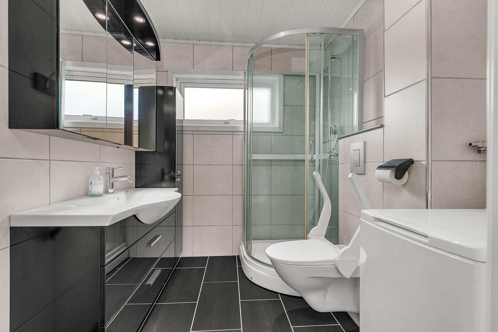 Her er det et romslig flislagt bad Galleribilde