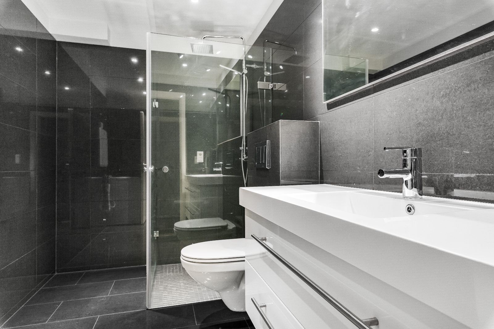 Moderne flislagt bad med regnfallsdusj og varme i gulv Galleribilde