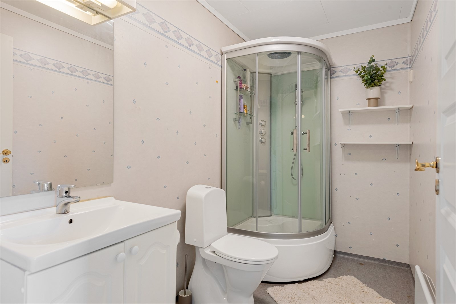 Pent bad med dusjhjørne, wc og servantinnredning. Galleribilde