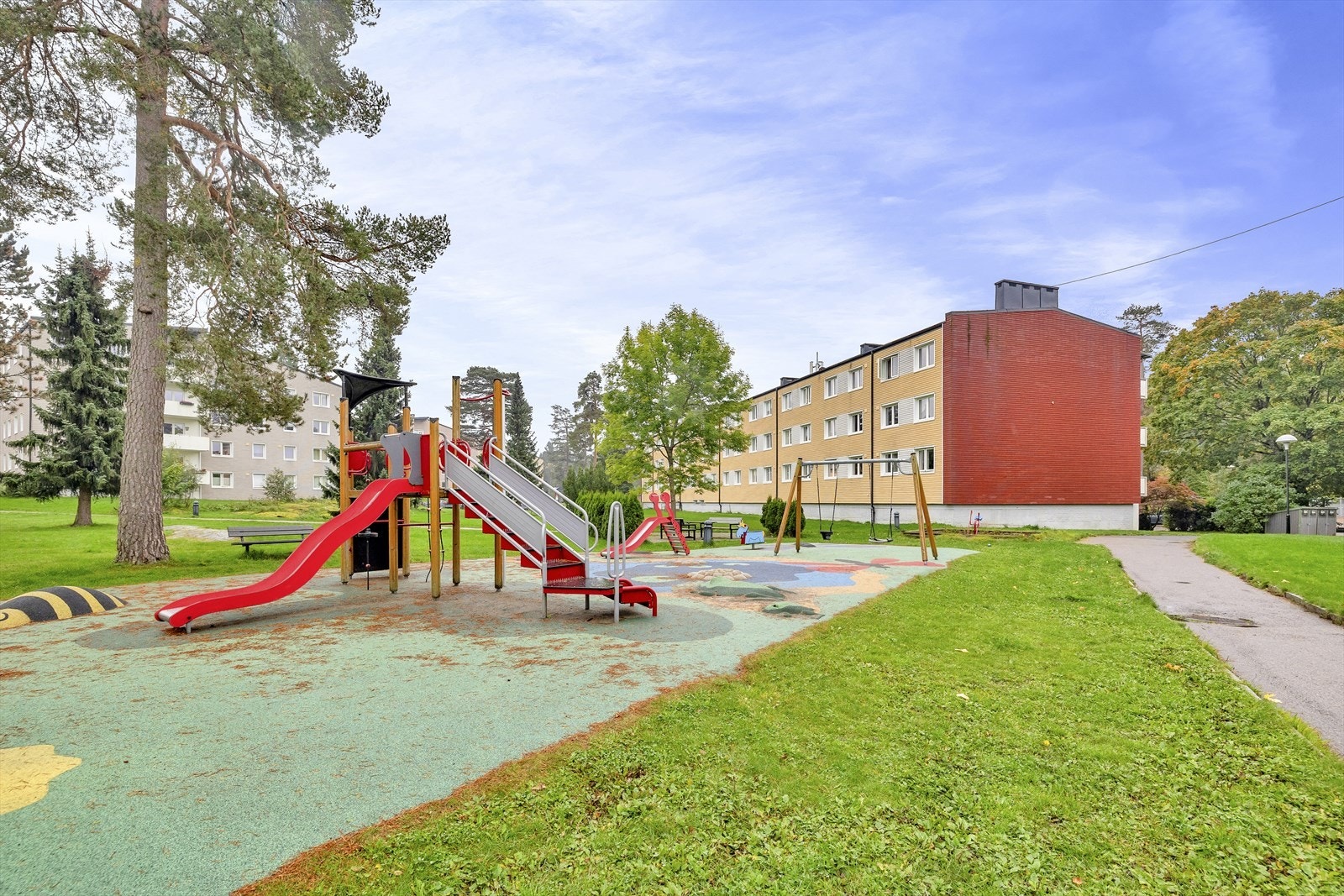 Pent opparbeidet fellesarealer med sittebenker og lekeplass Galleribilde