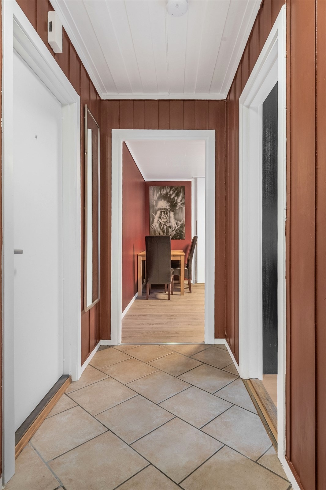 Vel inne har entreen flislagt gulv med varmekabler og malt panel på vegger. Galleribilde