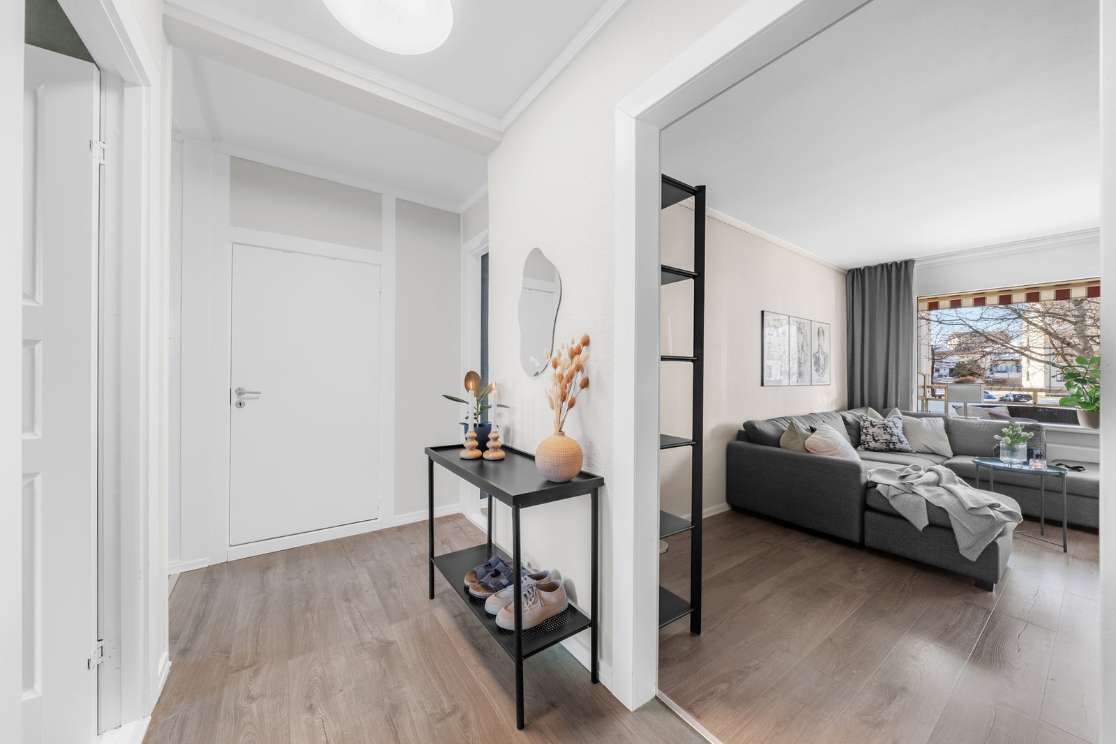 Entreen har inngang til baderom, kjøkken, soverom på begge sider og leilighetens stue Galleribilde