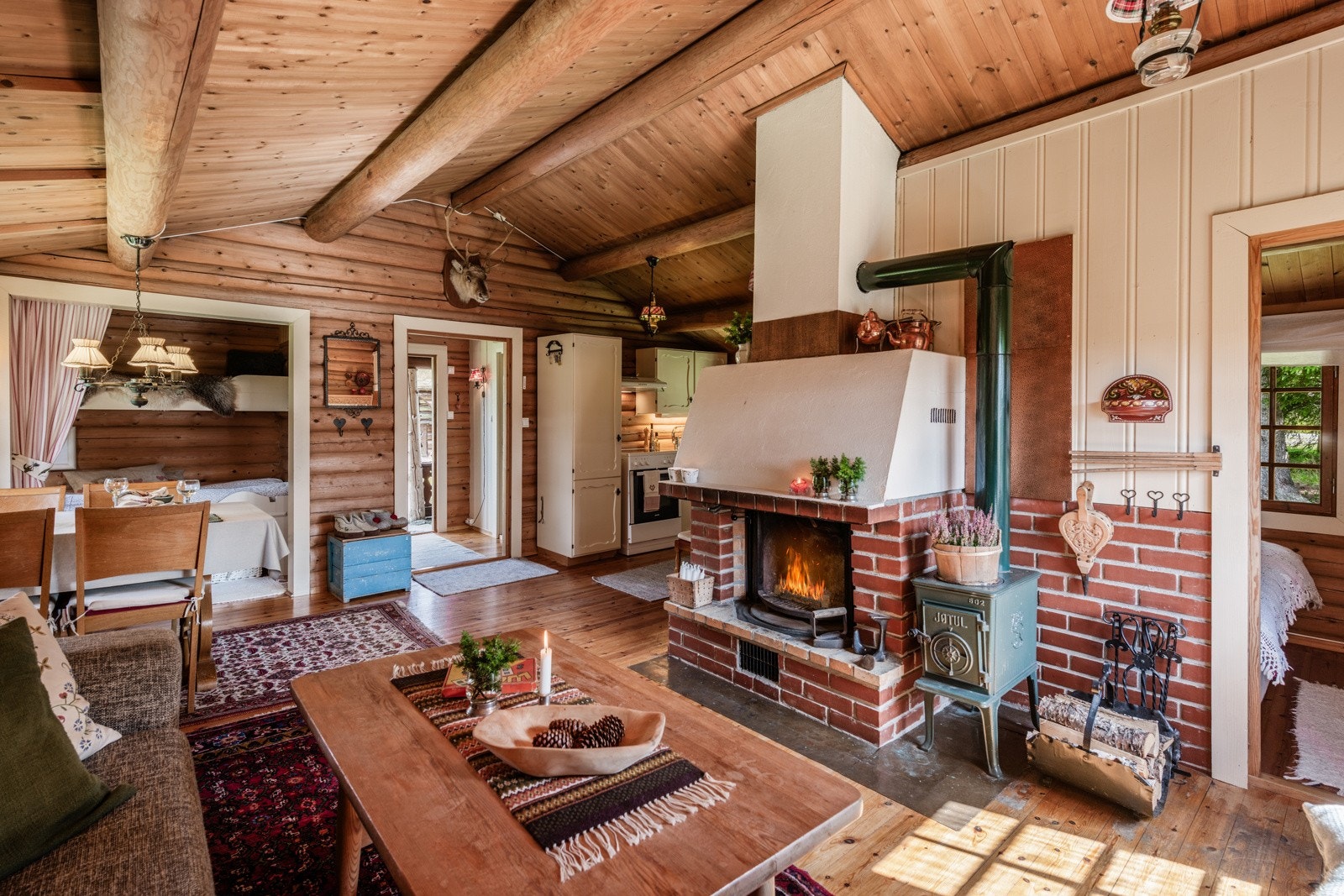 Stor og fin peis midt i rommet, perfekt å varme deg på etter en lang dag ute i kulden Galleribilde