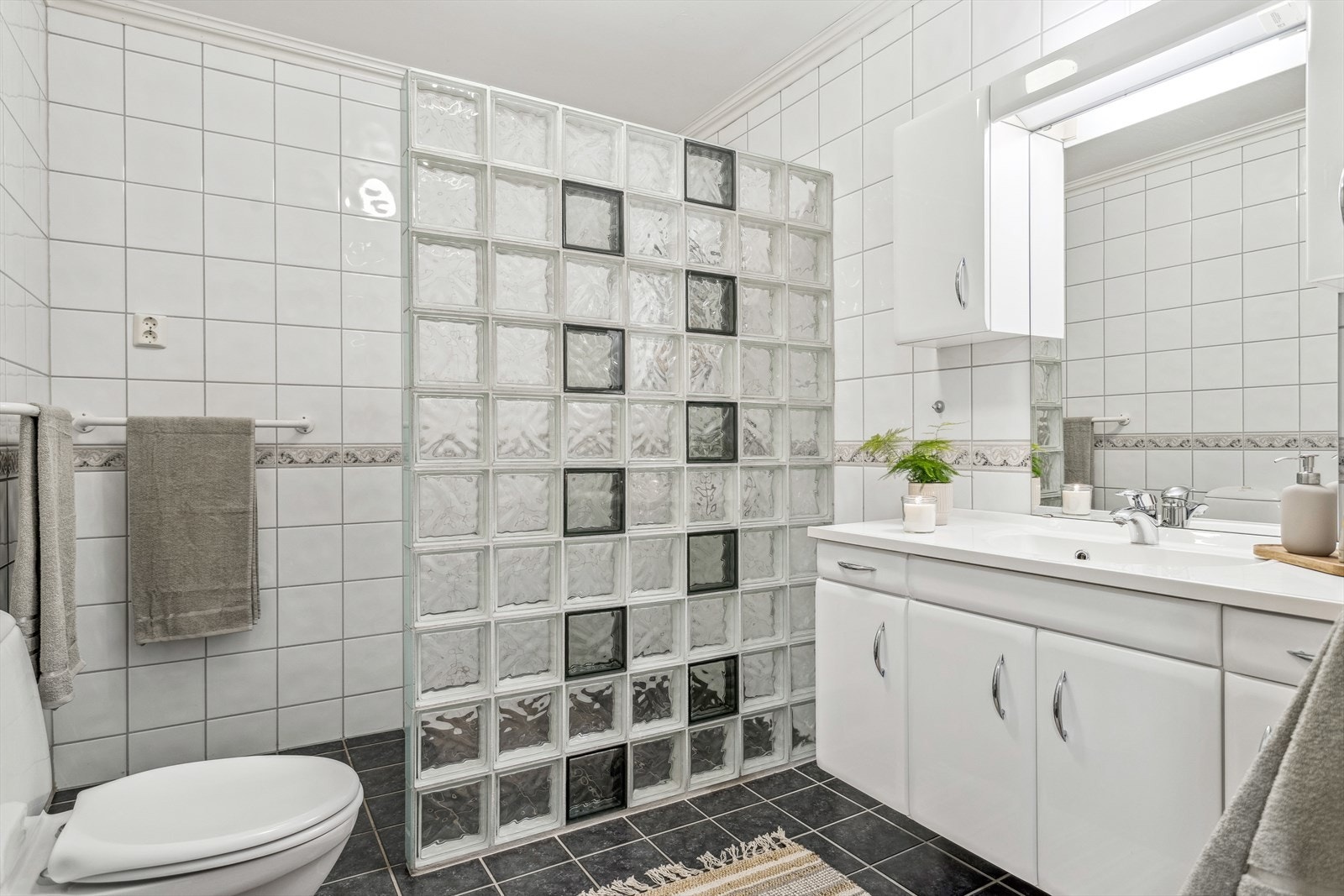 Pent og stilrent bad med gulvvarme, fliser på både gulv og vegger, samt malt overflate i himling. Galleribilde