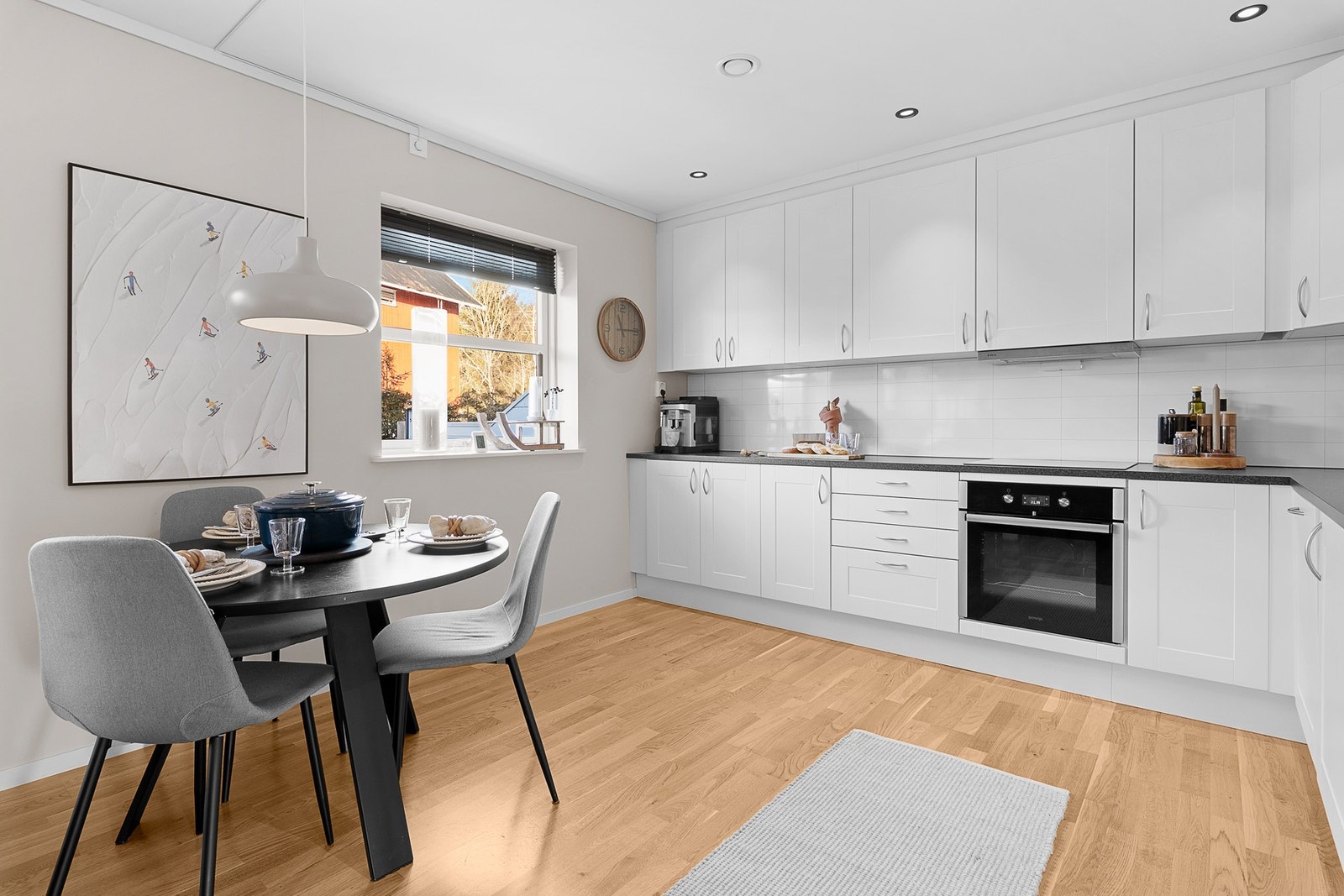 Lyst og stilrent kjøkken med takhøy innredning og integrerte hvitevarer. Galleribilde