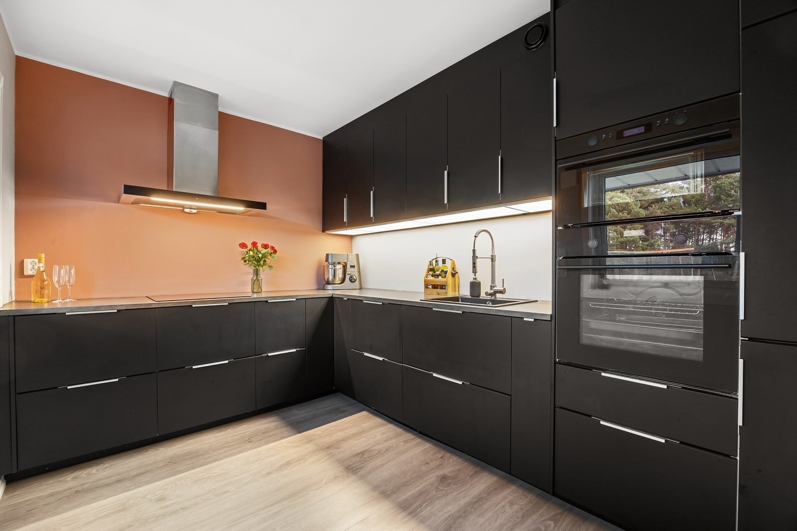 Delikat innredning fra Ikea fra 2018 med sorte fronter, laminert benkeplate og integrerte hvitevarer Galleribilde