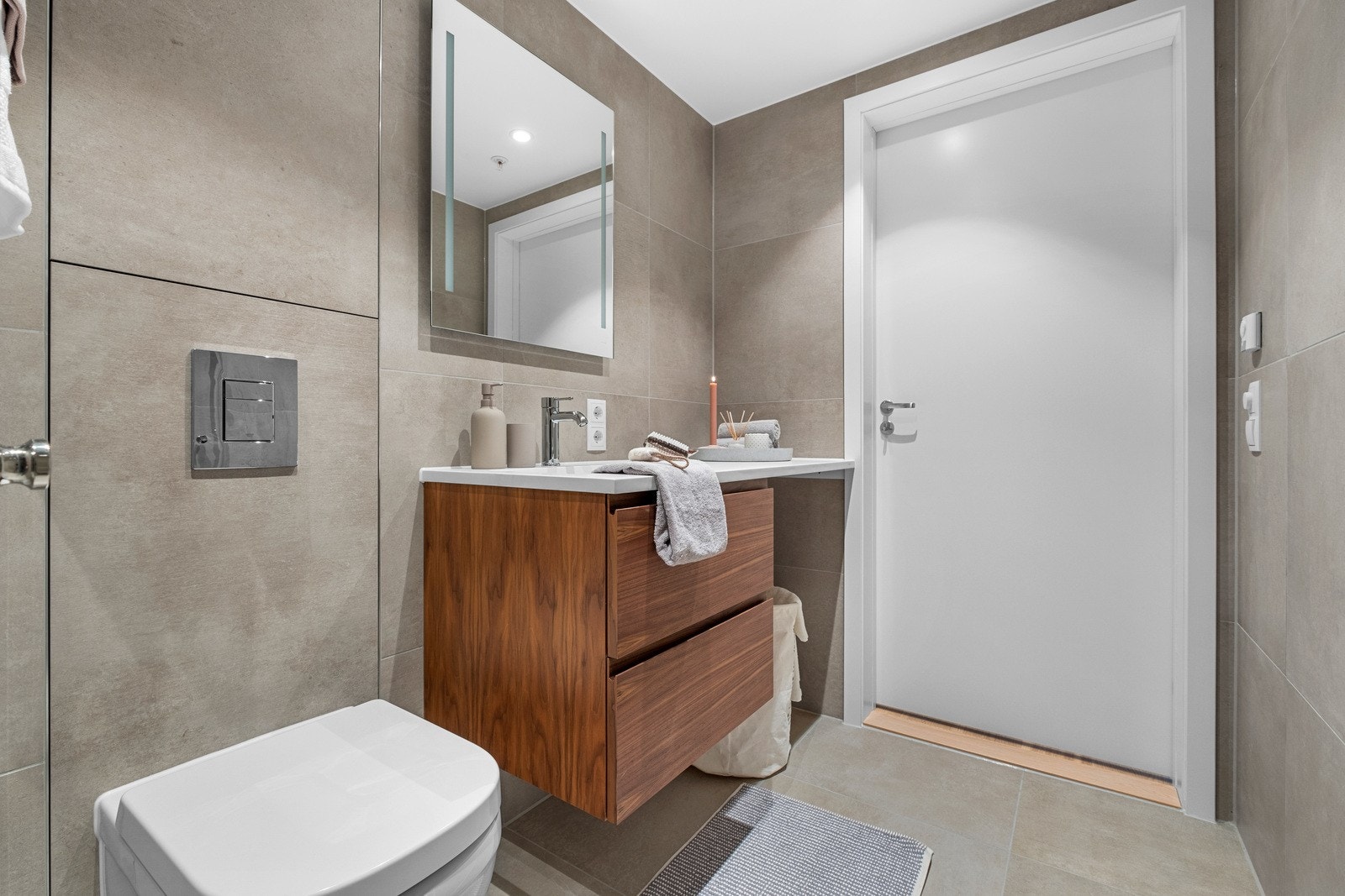 Solide fliser på vegger og gulv, downlights i tak og opplegg for vaskemaskin. Galleribilde