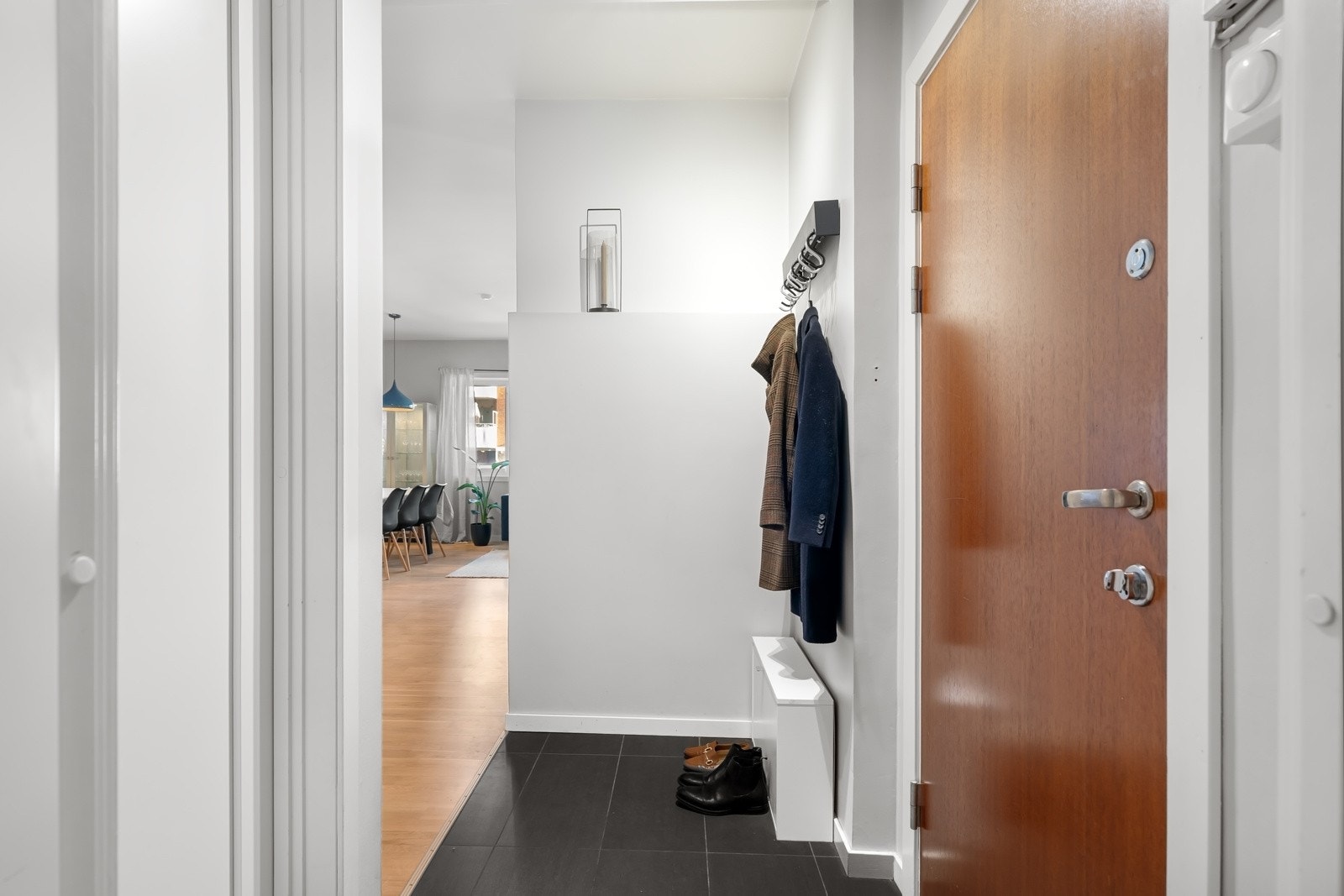 Lyst og innbydende inngangsparti som gir et godt førsteinntrykk av boligen. Her er det mulighet for å henge opp klær på knagger eller mulighet for å oppbevare dem i et praktisk garderobesystem. Galleribilde
