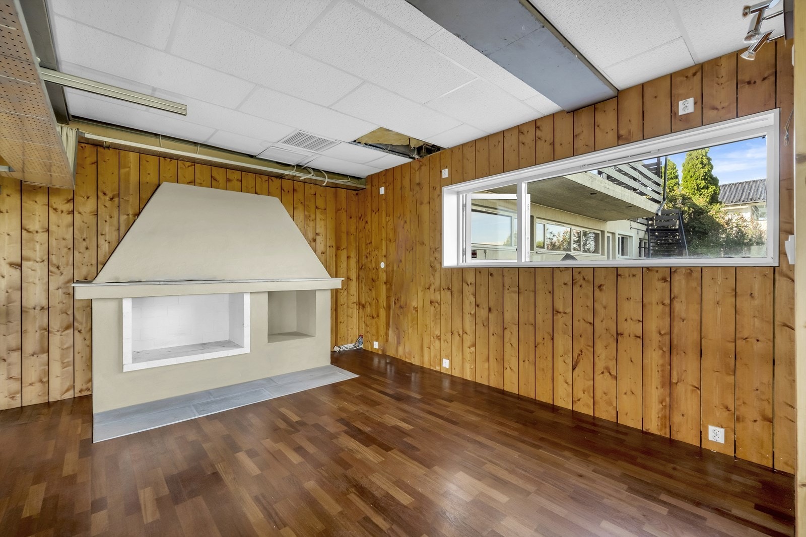 Fra bibliotek / peisestuen er det en liten trapp ned til mesaninen. Her var det tiltenkt en peis på mesaninen - men den ble ikke ferdigstilt og er ikke brukbar. Galleribilde