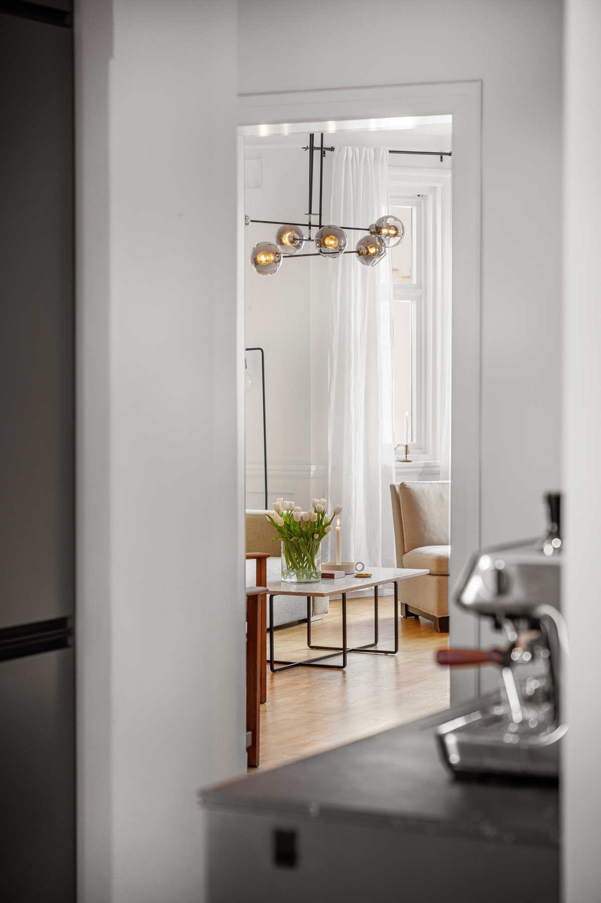 Stue sett fra kjøkkenet - åpent og lyst mellom rommene i leiligheten. Galleribilde