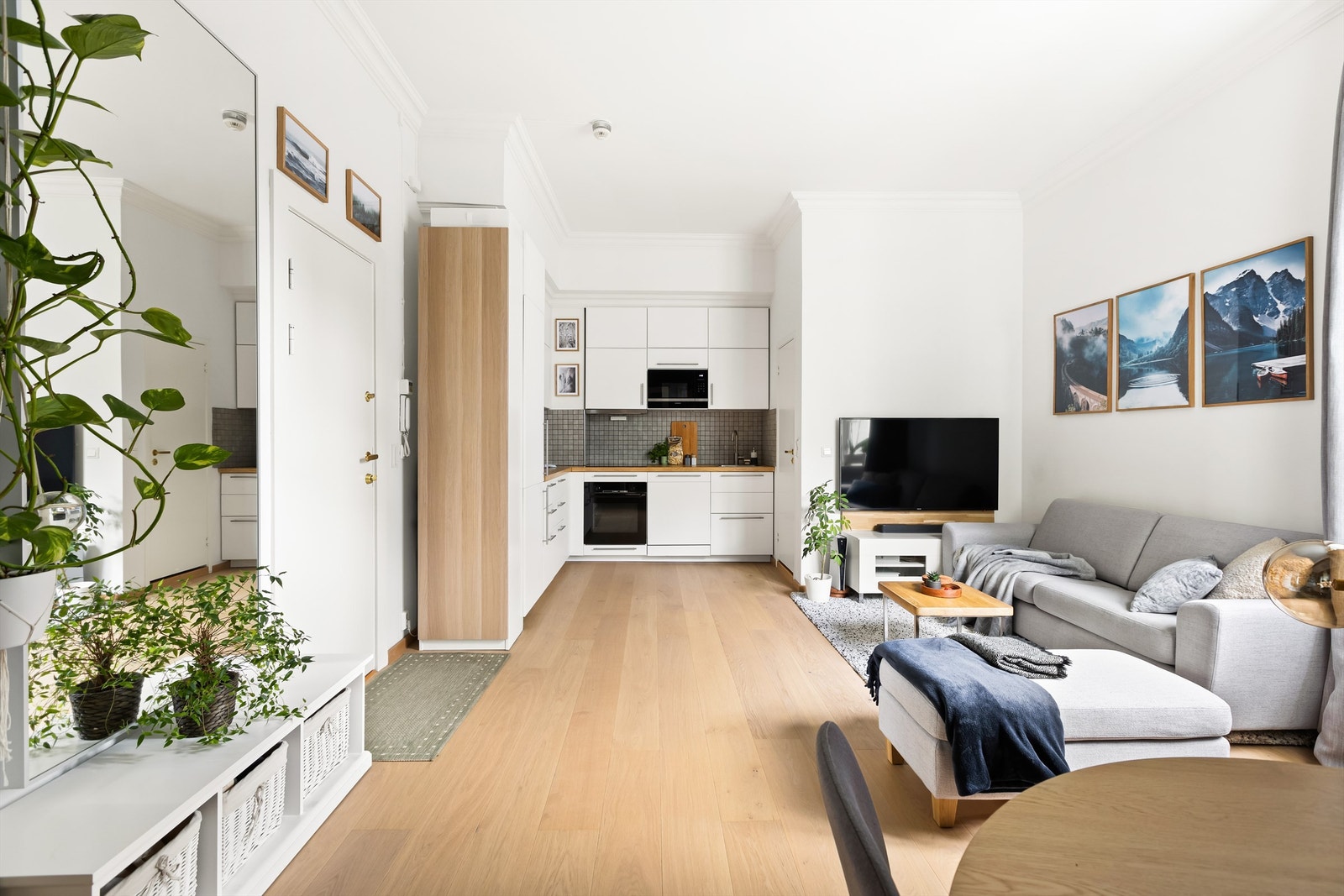 Den åpne løsningen gjør det enkelt å tilpasse møbleringen etter dine behov, og skaper en sømløs overgang mellom stue og kjøkken. Galleribilde