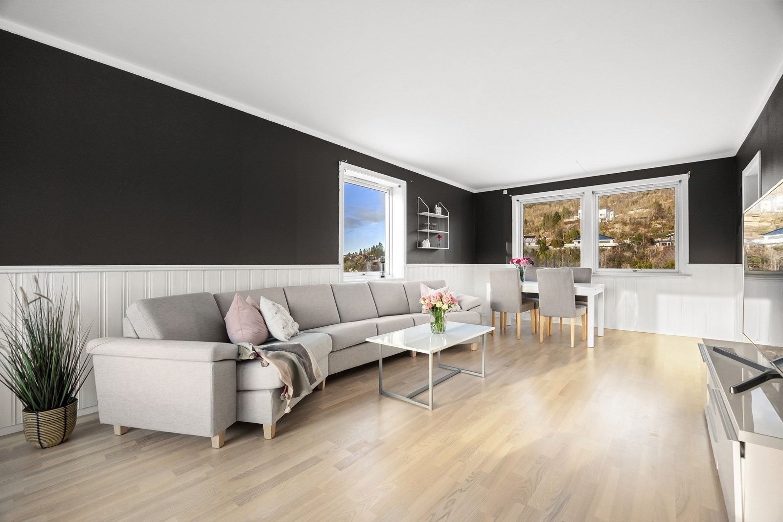 Stuen er av fin størrelse og en utforming som gjør det enkelt å møblere i ulike sosiale soner. Det er god plass til sofagruppe, spisebord og øvrig ønsket møblement Galleribilde