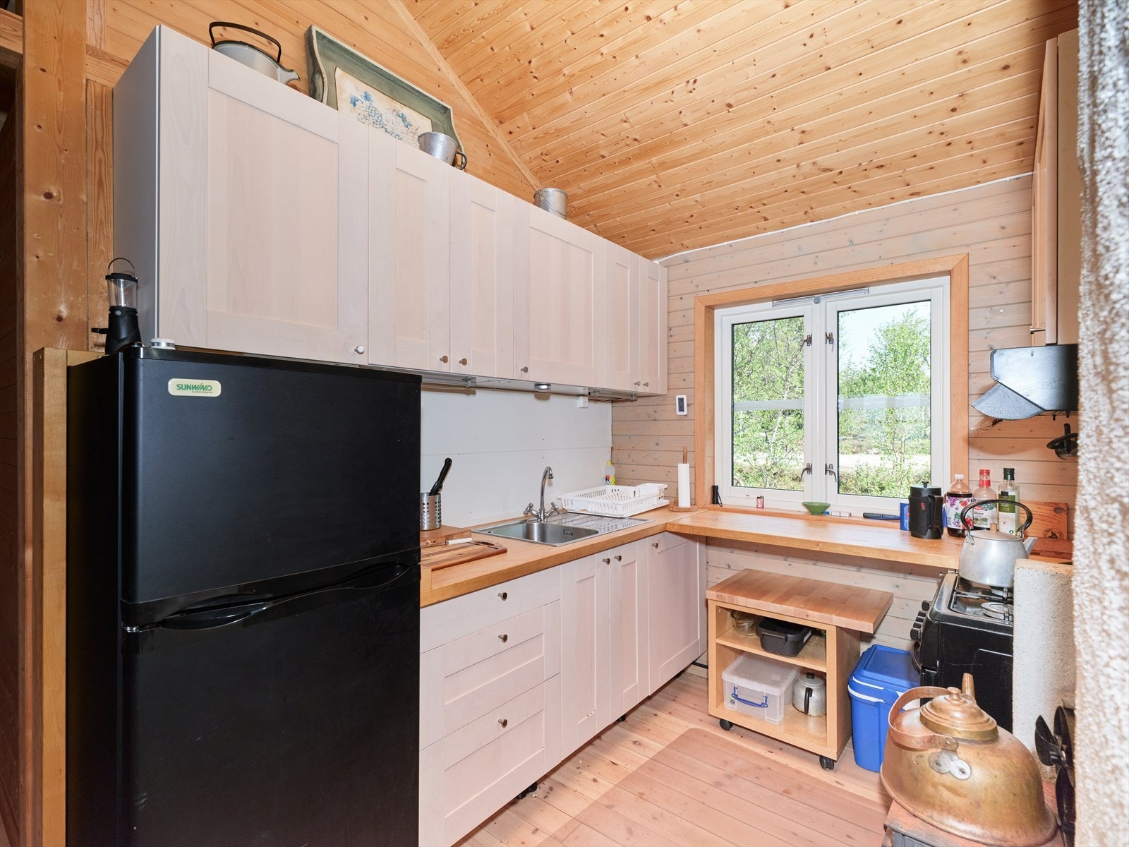 Pent kjøkken med komfyr og kjøleskap drevet på gass. Galleribilde