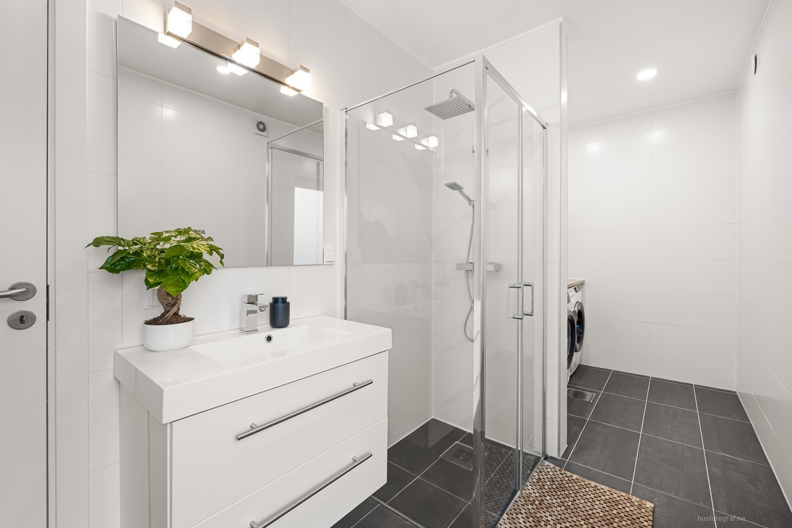 Badet i 1.etasje er pent flislagt med lyse, moderne fliser og varmekabler i gulv. Galleribilde