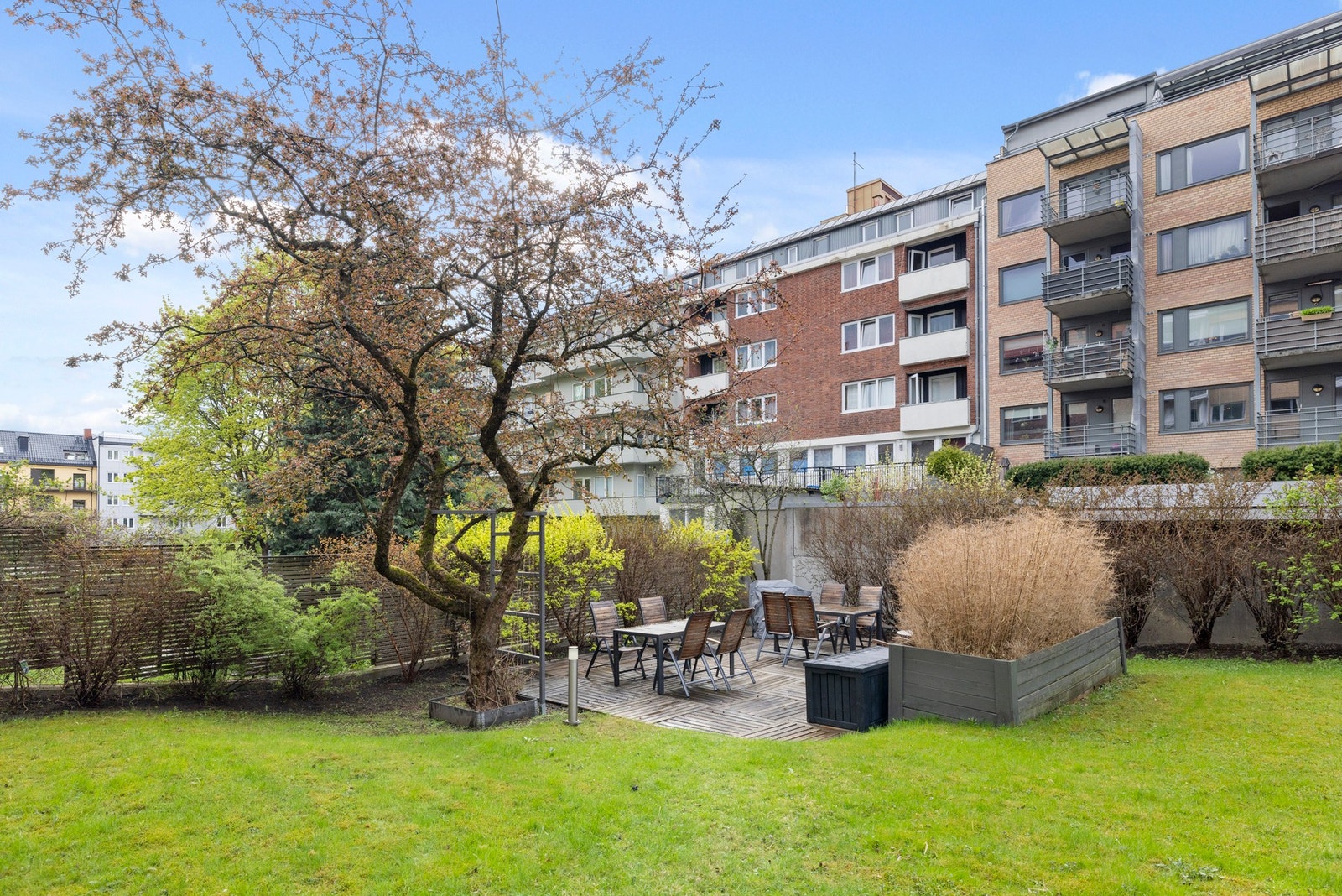 Bakgården er pent opparbeidet med flere sittegrupper og grøntareal. Galleribilde