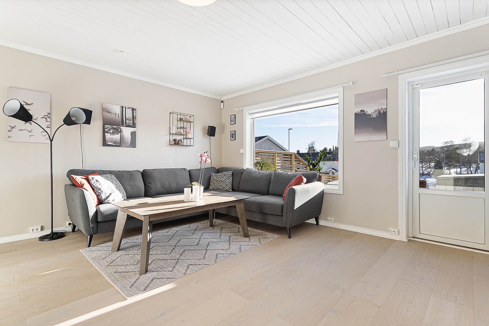 Hyggelig stue med god plass til møblering. Lyse overflater og store vindusflater bidrar til en behagelig romfølelse Galleribilde