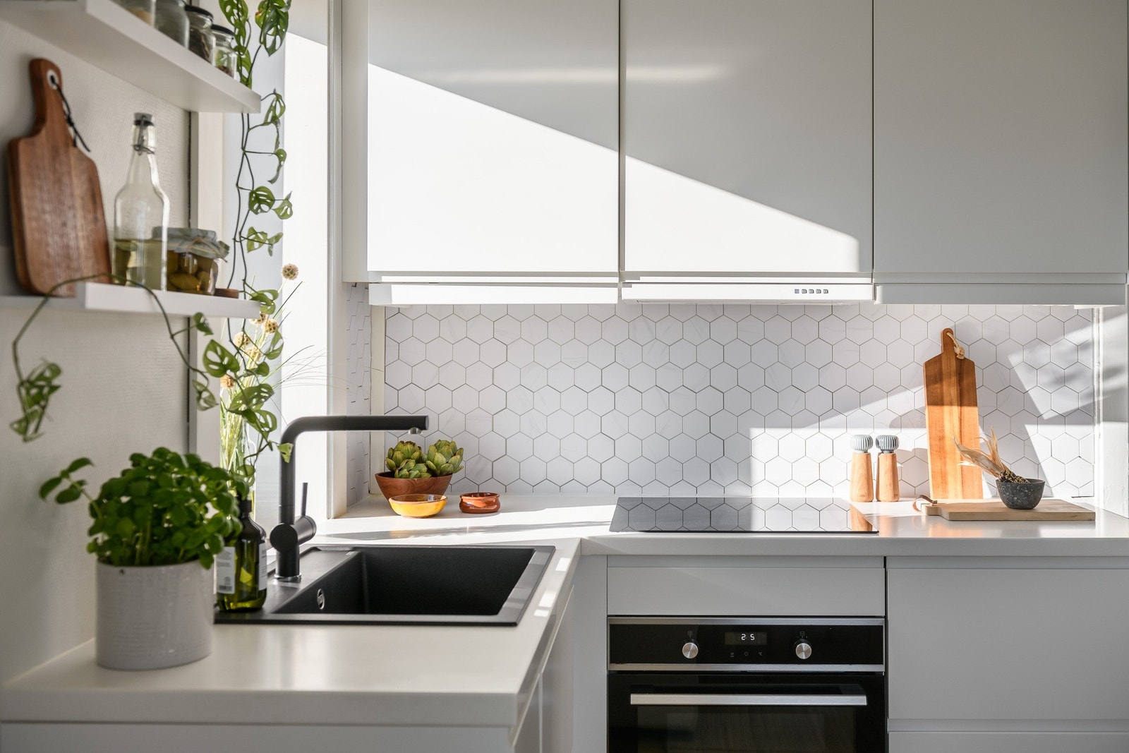 Epoq-kjøkkenet er moderne og stilrent med hvit laminatbenkeplate og vaskekum i sort kompositt. Galleribilde