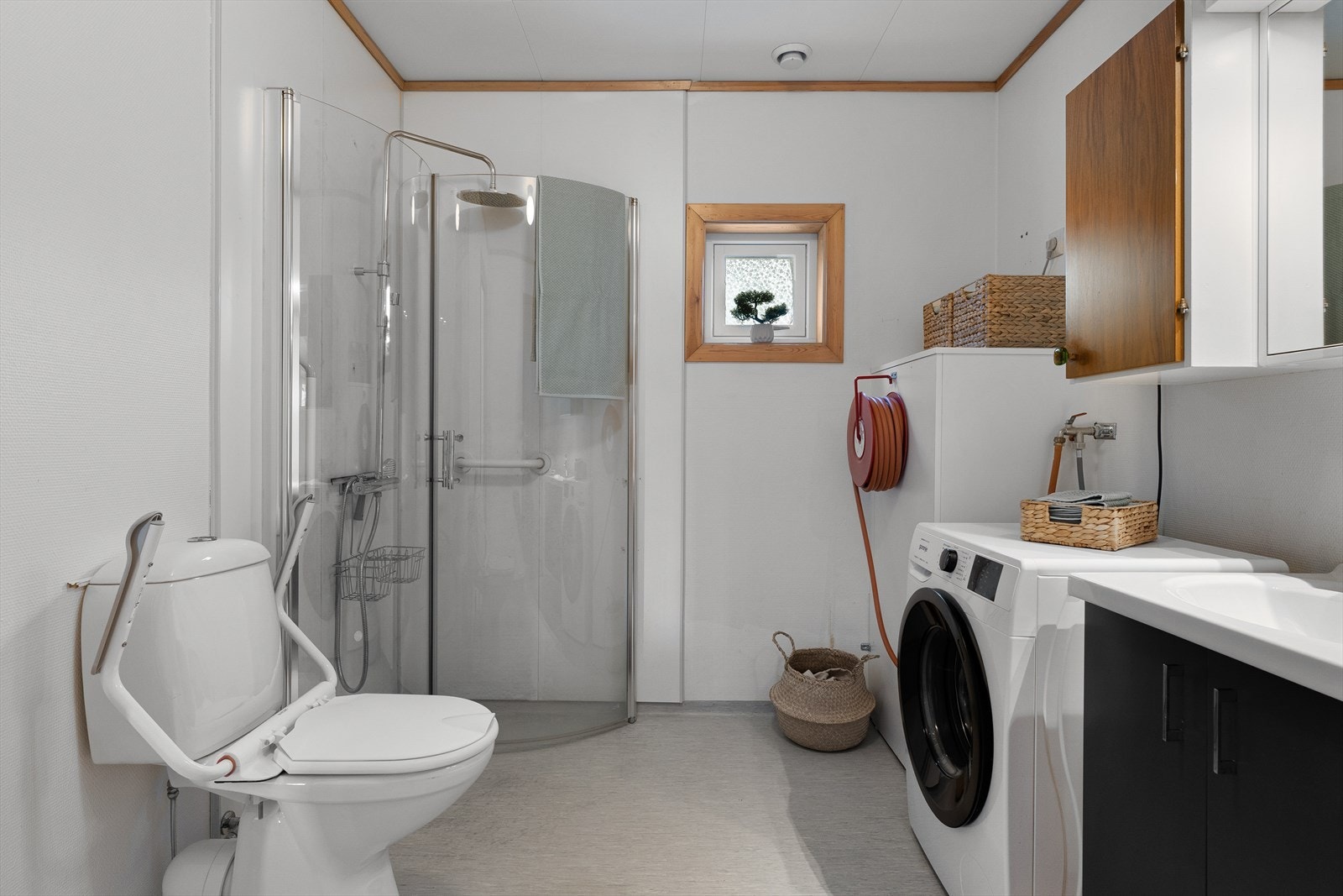 Badet har belegg på gulv, baderomsplater og malt strie på vegger. Galleribilde